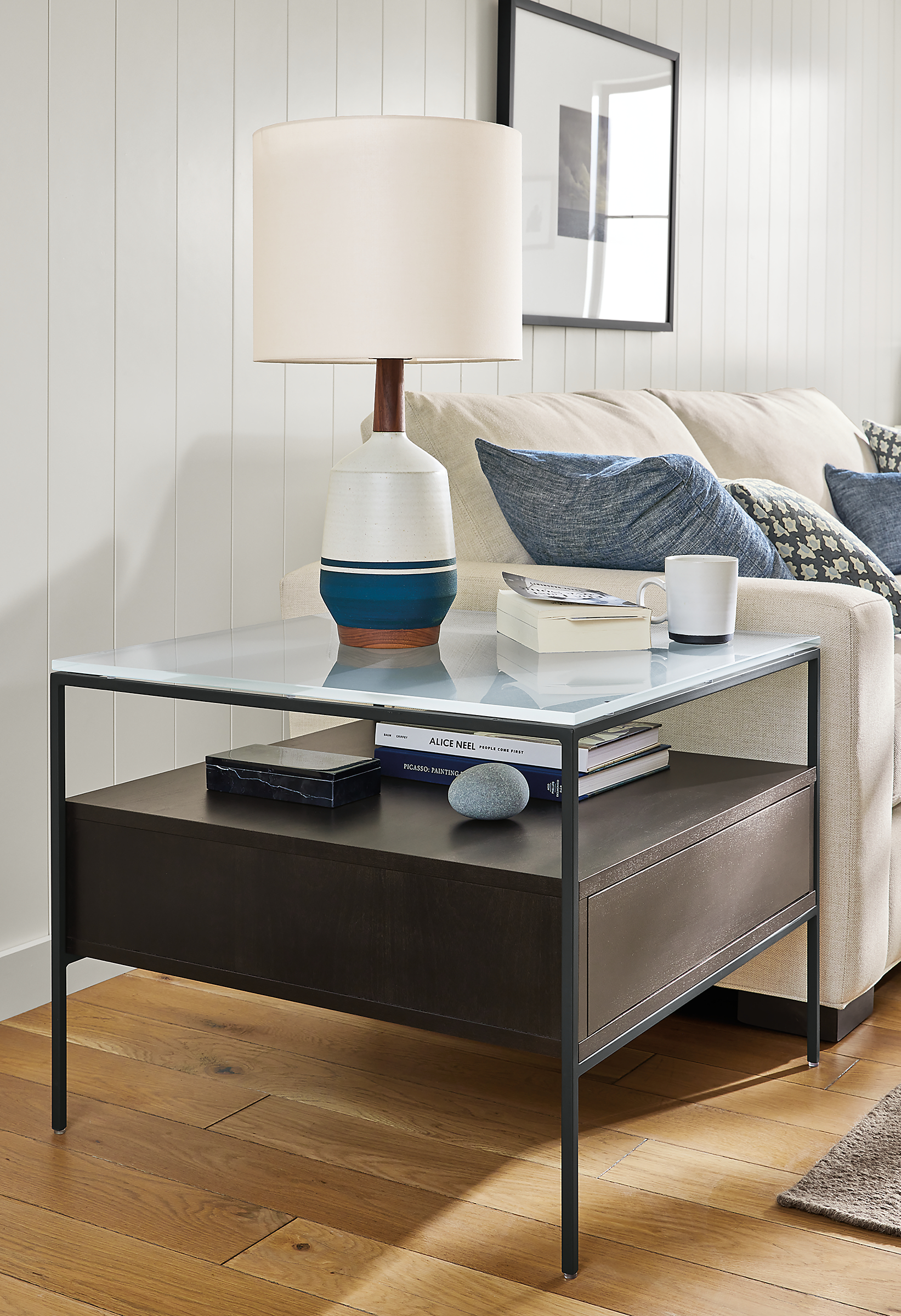 Living area with Williams end table in charcoal with satin etched glass top and Meriden table lamp in white and blue.