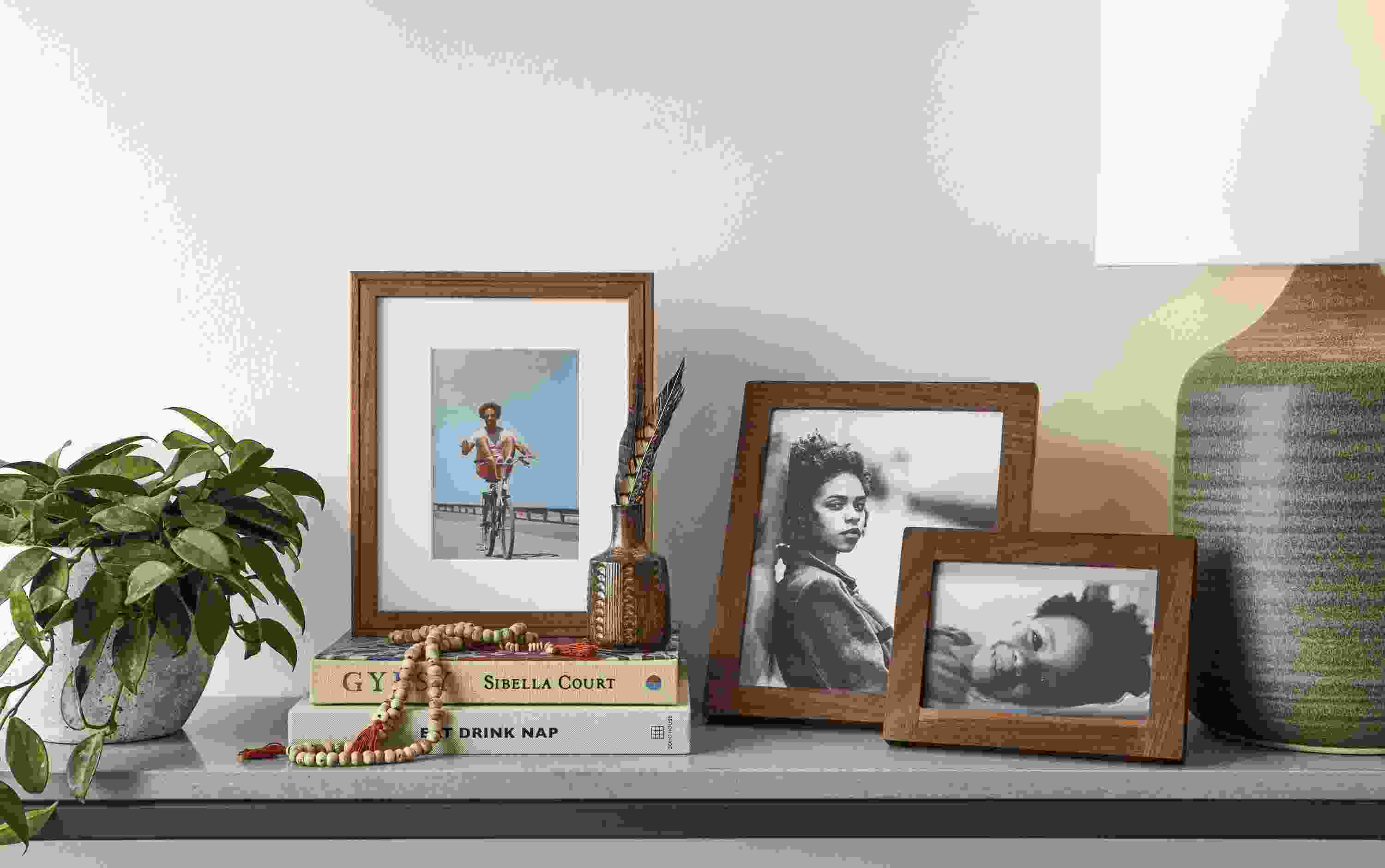 Detail of Wilson picture frame and Quadra picture frames in walnut.