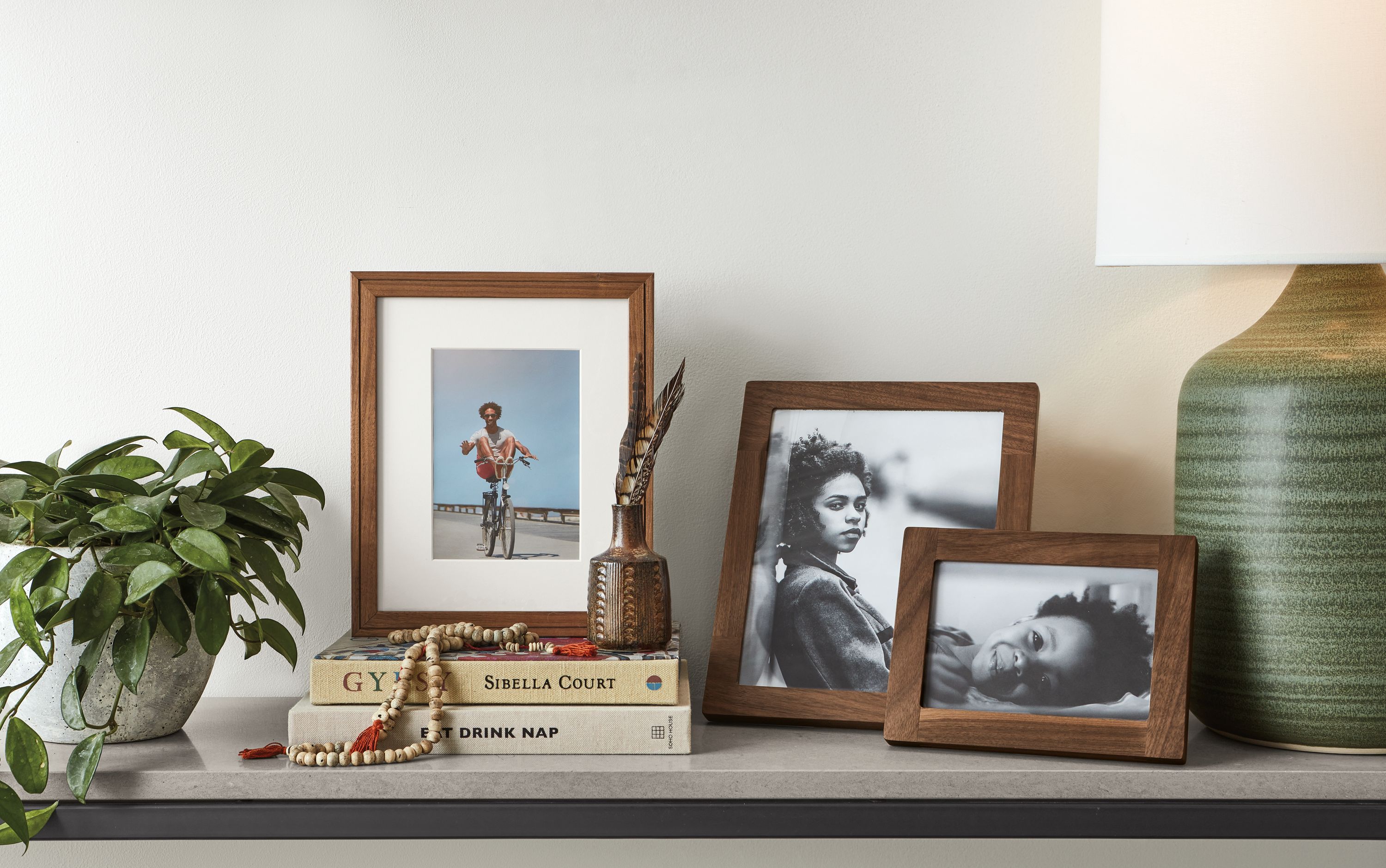 Detail of Wilson picture frame and Quadra picture frames in walnut.