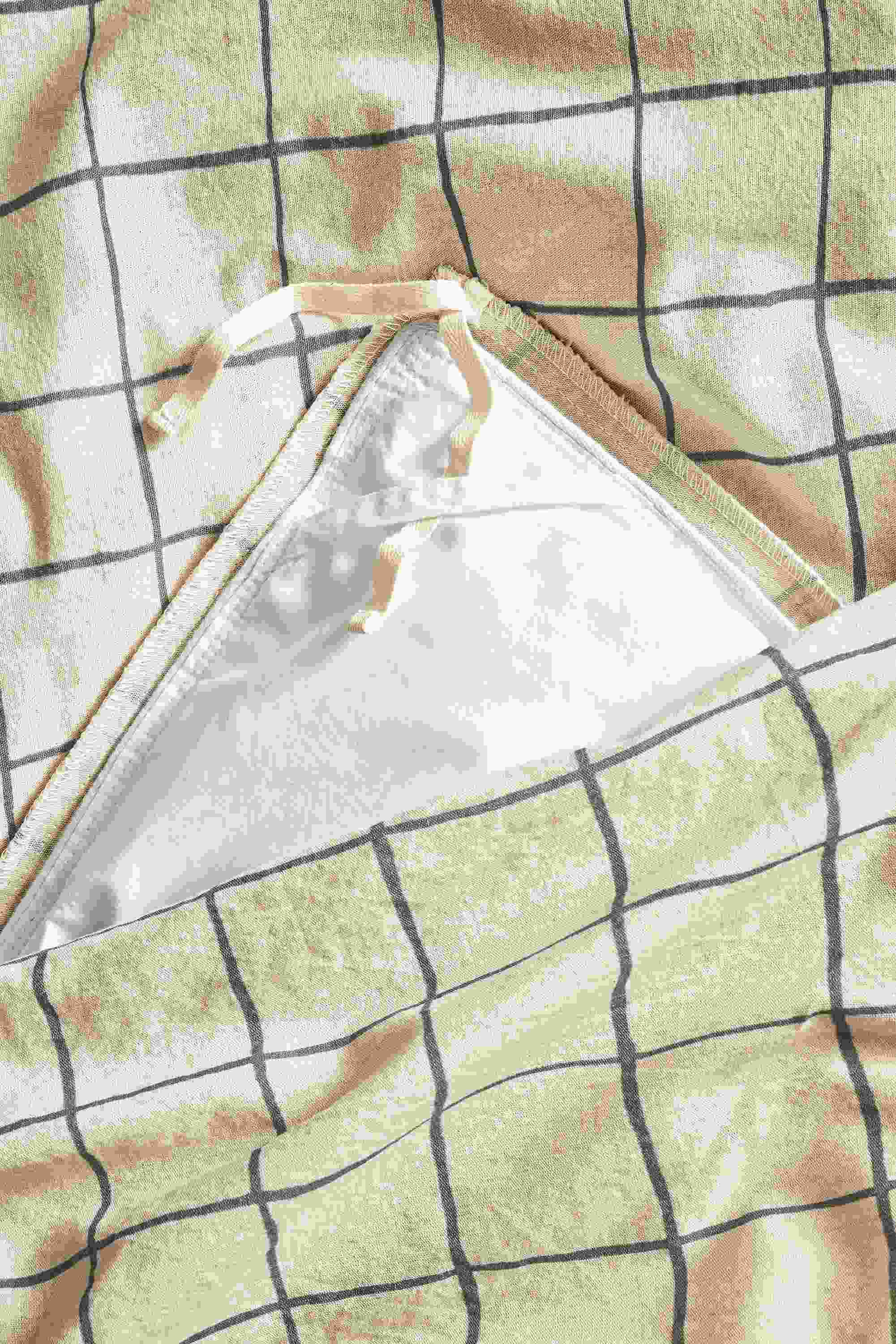 Detail of inside corner of window full/queen duvet set in charcoal.