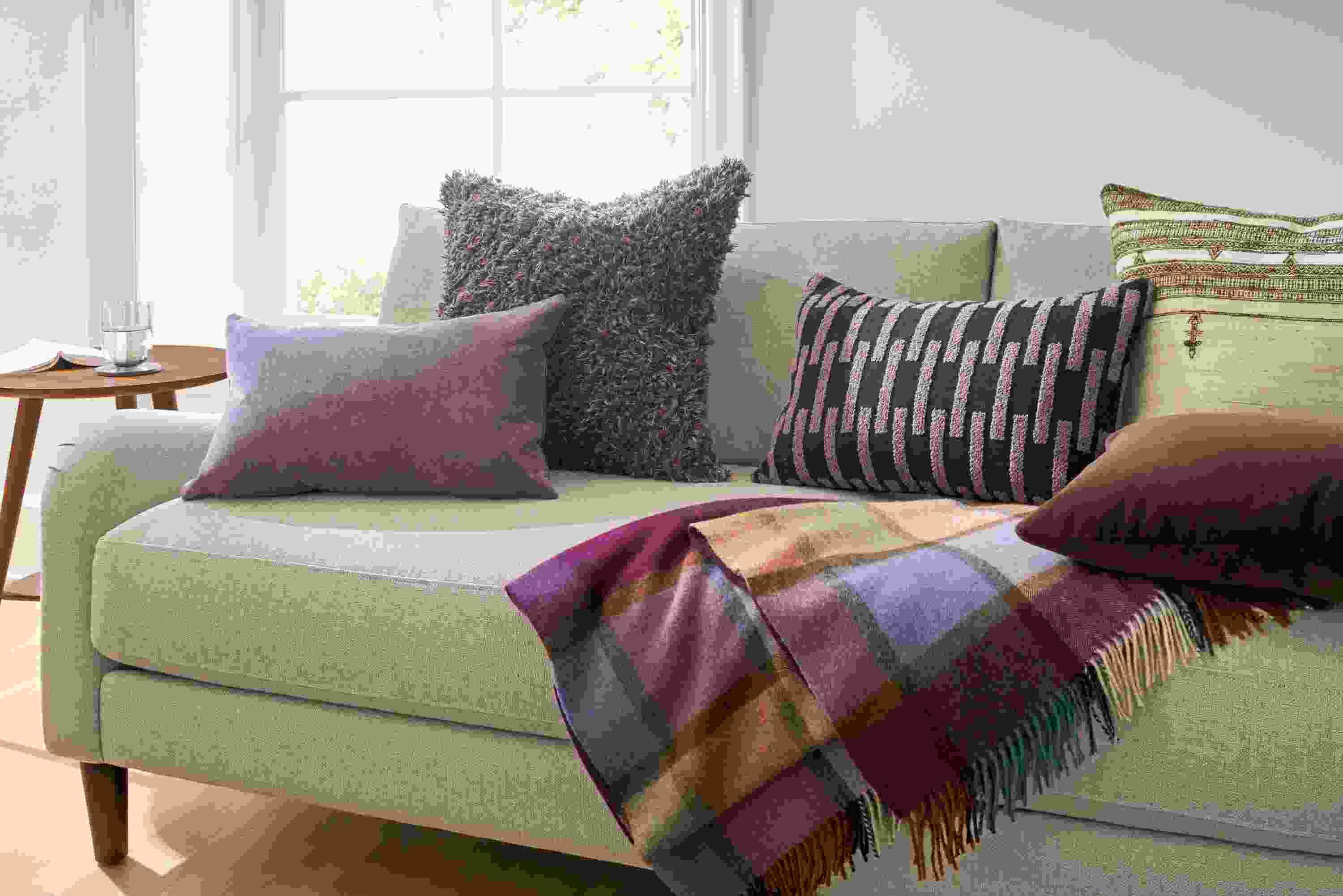 Living room with Windsor, Vinten, Ida and Bhujodi throw pillows on an Eloise sofa in Sumner Flax.