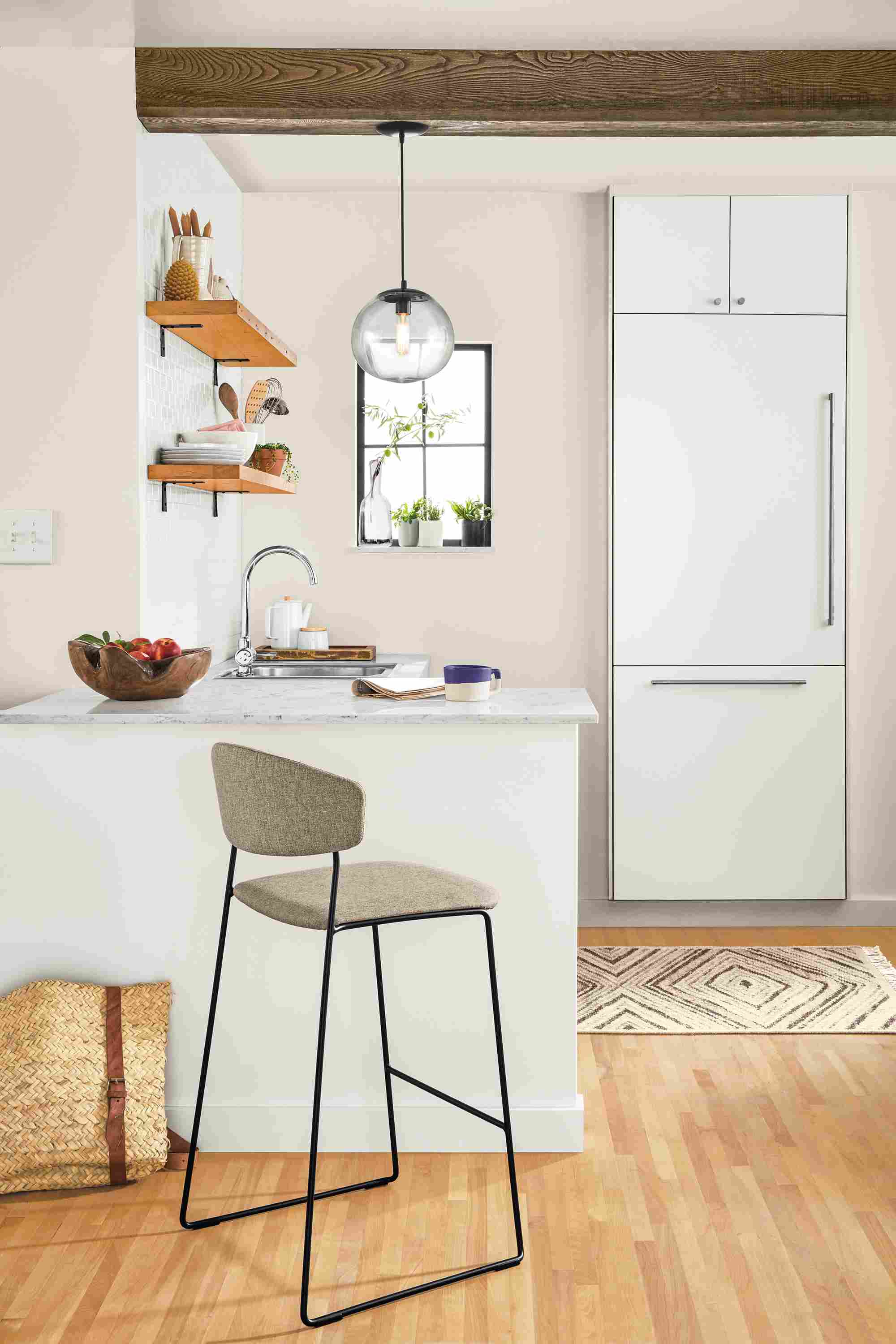Kitchen counter with Wolfgang counter stool in Medley Oatmeal with black legs and Howard globe pendant light.