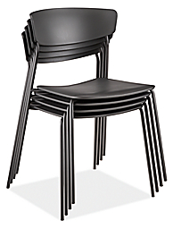 detail of 4 stacked wolfgang outdoor side chairs in black.