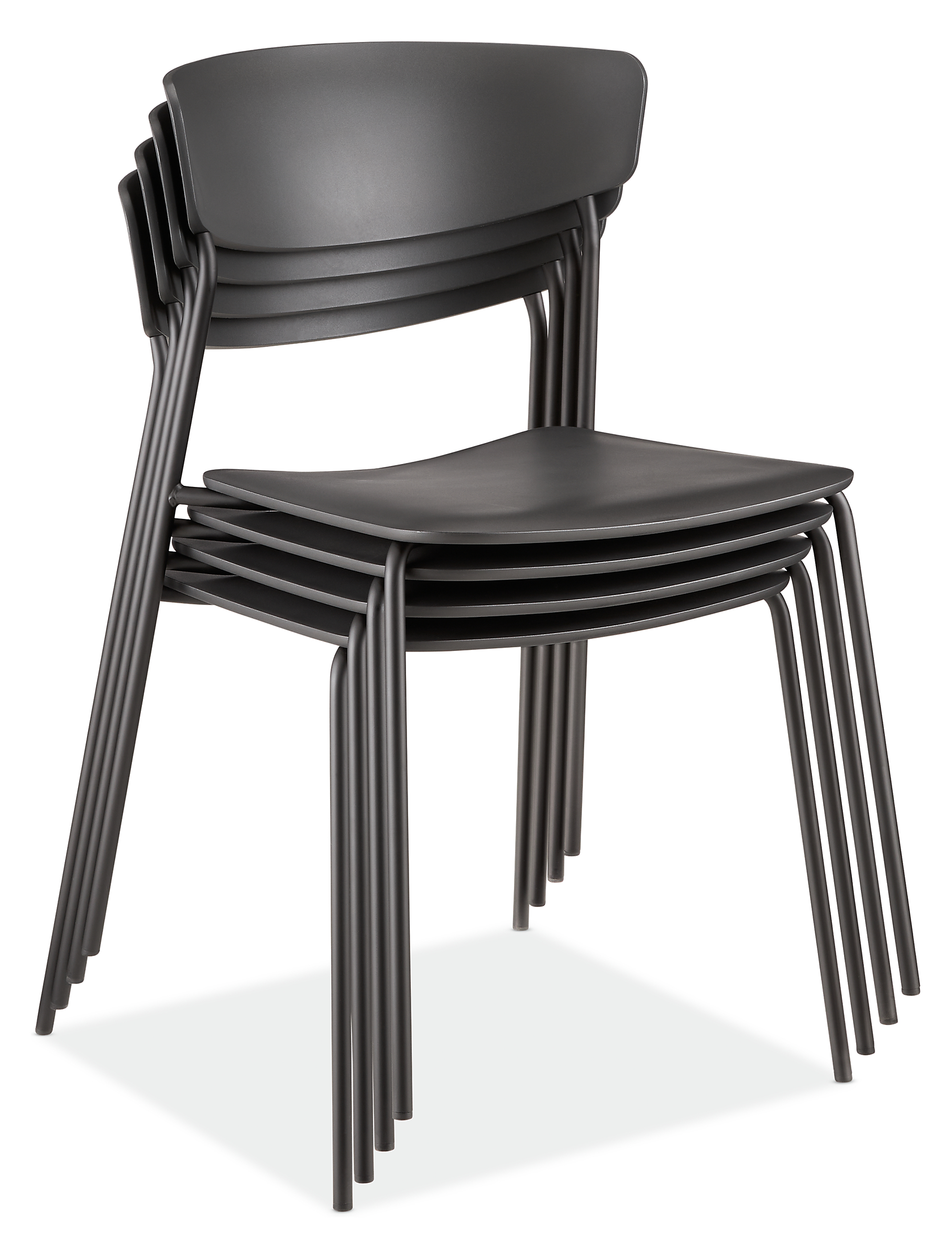 detail of 4 stacked wolfgang outdoor side chairs in black.