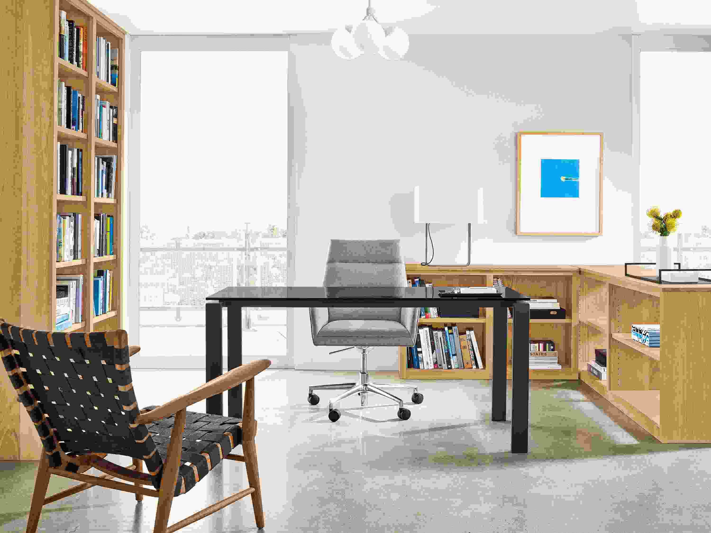 Detail of office setting with Woodwind bookcases, Rand table, Tenley office chair and Ira lounge chair.