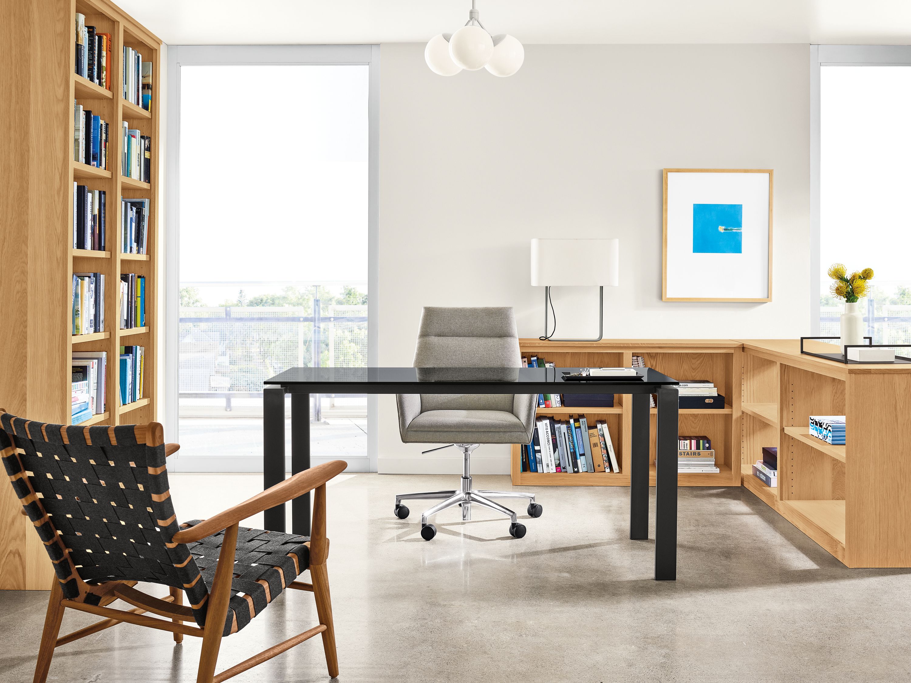 Detail of office setting with Woodwind bookcases, Rand table, Tenley office chair and Ira lounge chair.