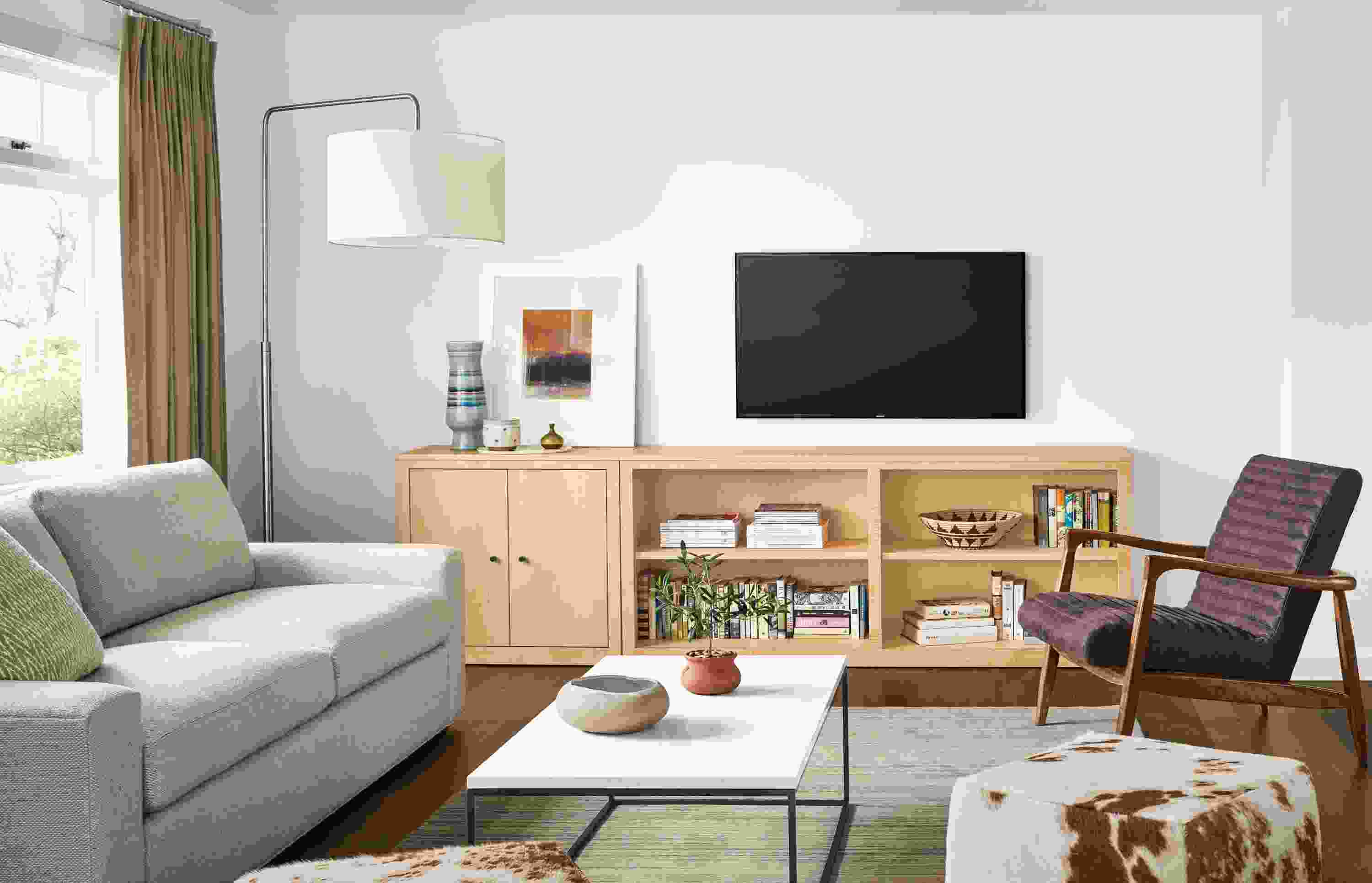 Living room with Woodwind two-door bookcases in maple and Harding sofa in Arin Linen.