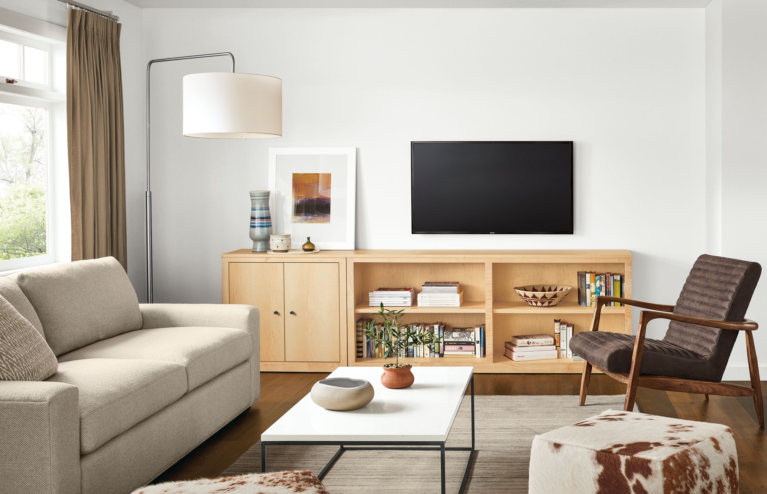 Living room with Woodwind two-door bookcases in maple and Harding sofa in Arin Linen.