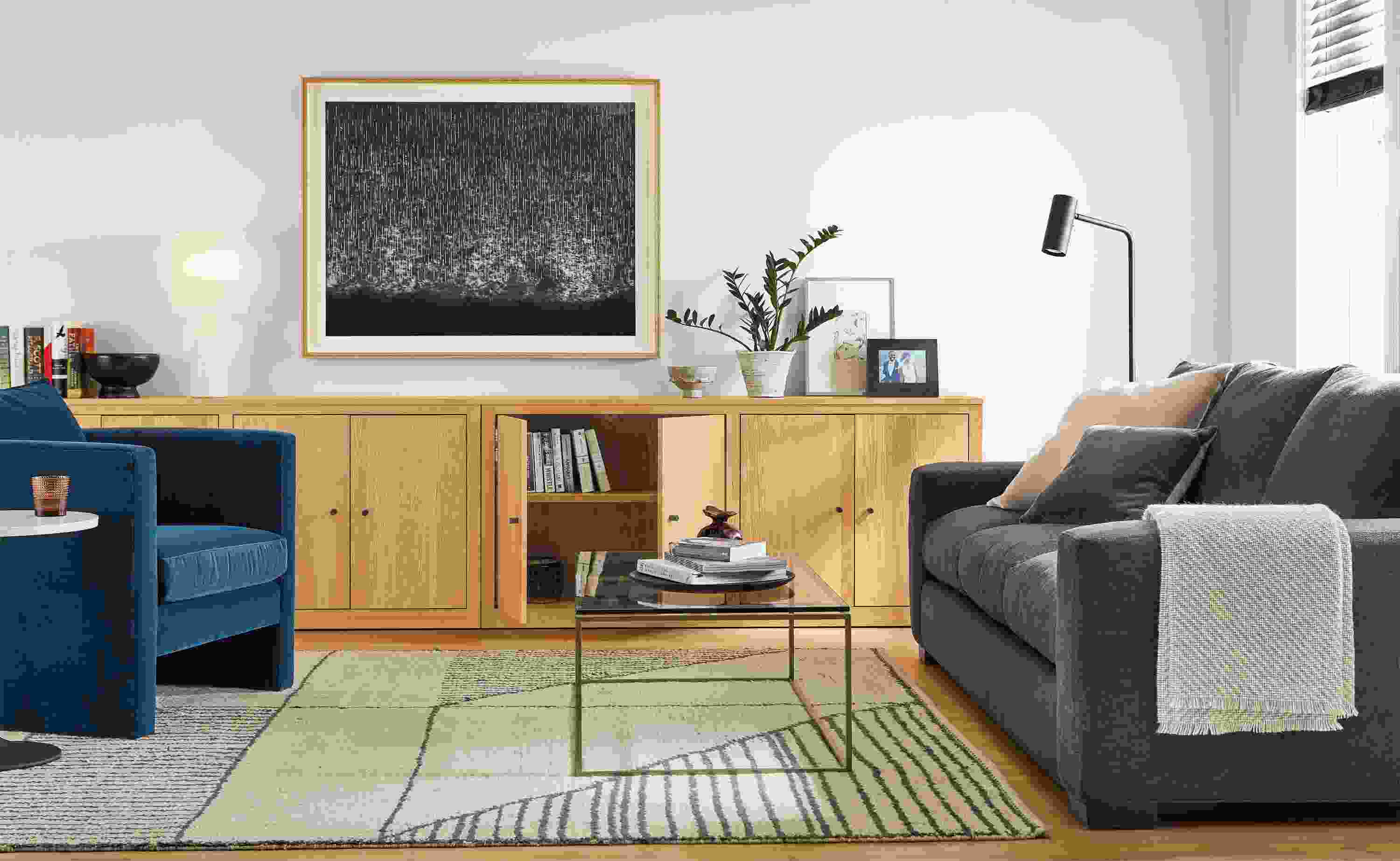 Detail of Woodwind custom bookcases in living room with silva chair in banks denim and metro sofa.