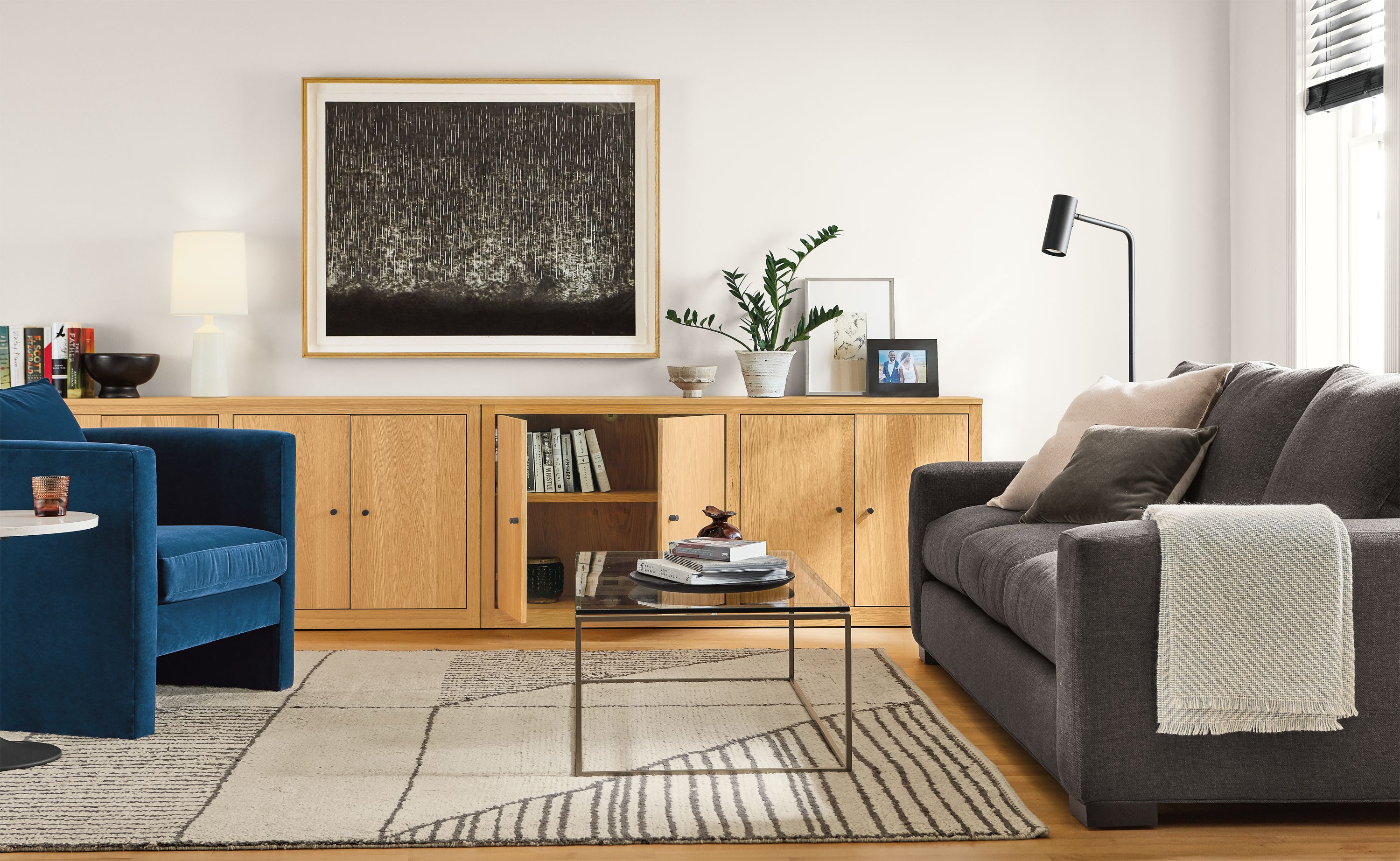 Detail of Woodwind custom bookcases in living room with silva chair in banks denim and metro sofa.
