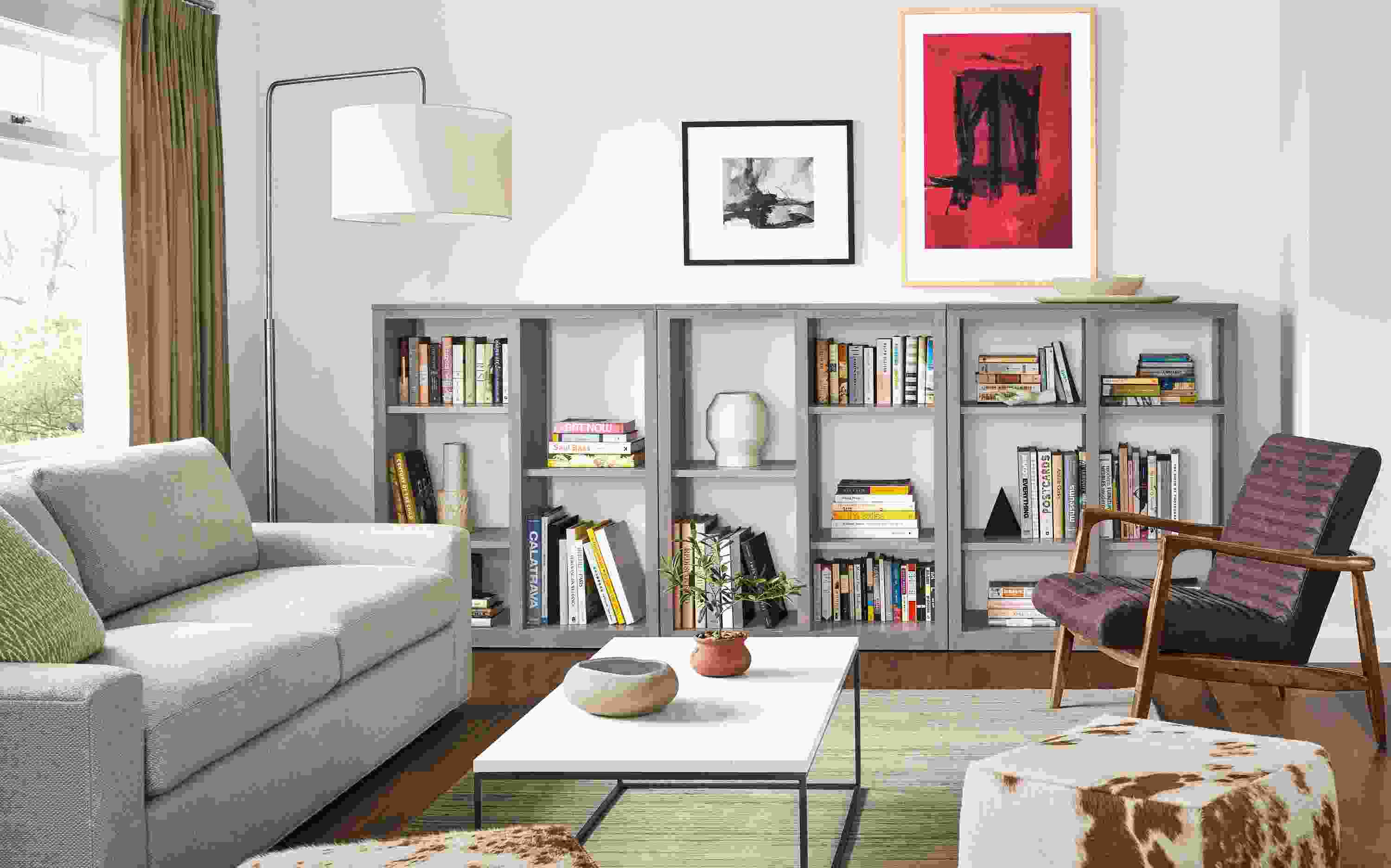 Living room with 3 Woodwind open-back bookcases in shell and Harding sofa in Arin Linen.