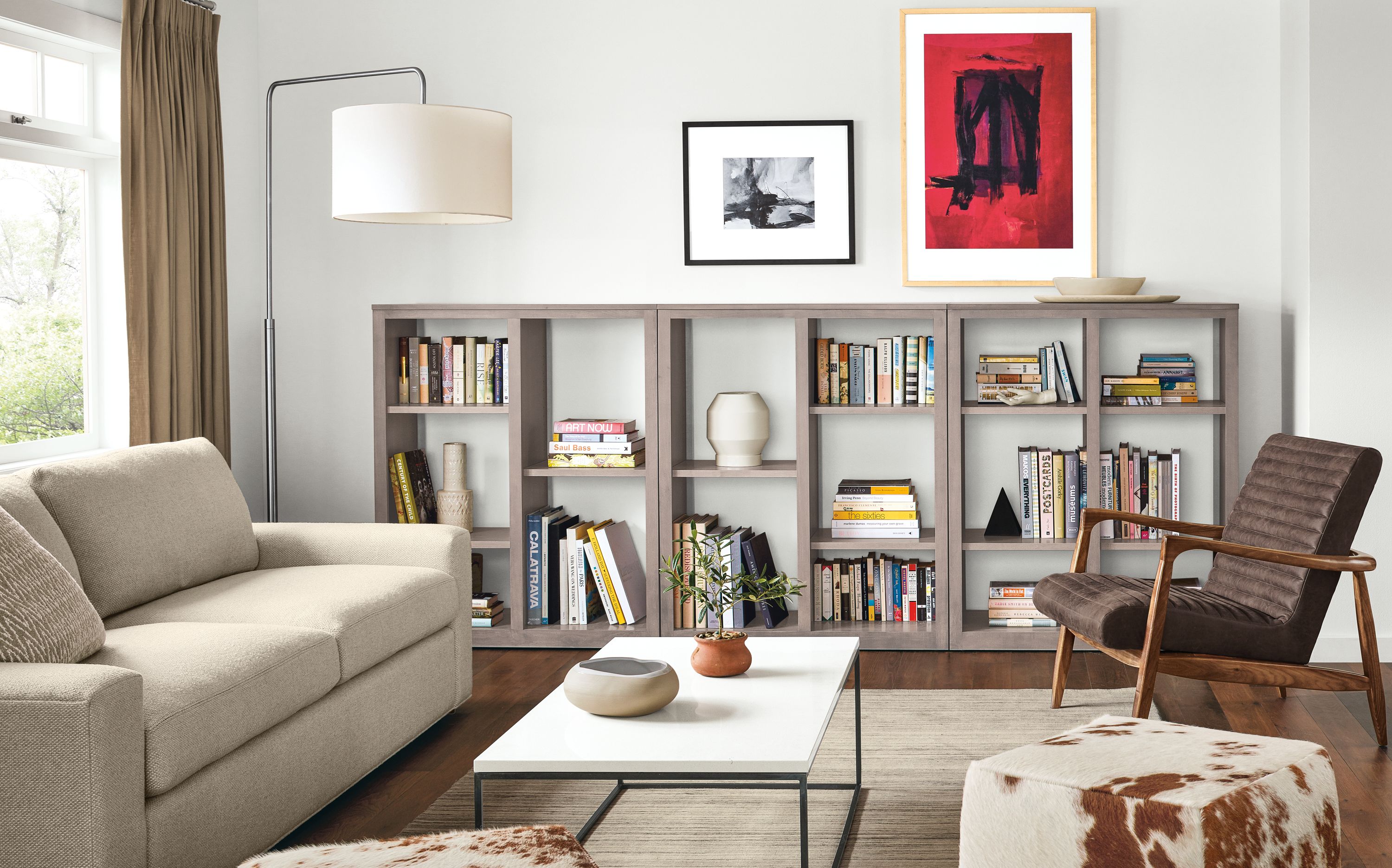 Living room with 3 Woodwind open-back bookcases in shell and Harding sofa in Arin Linen.