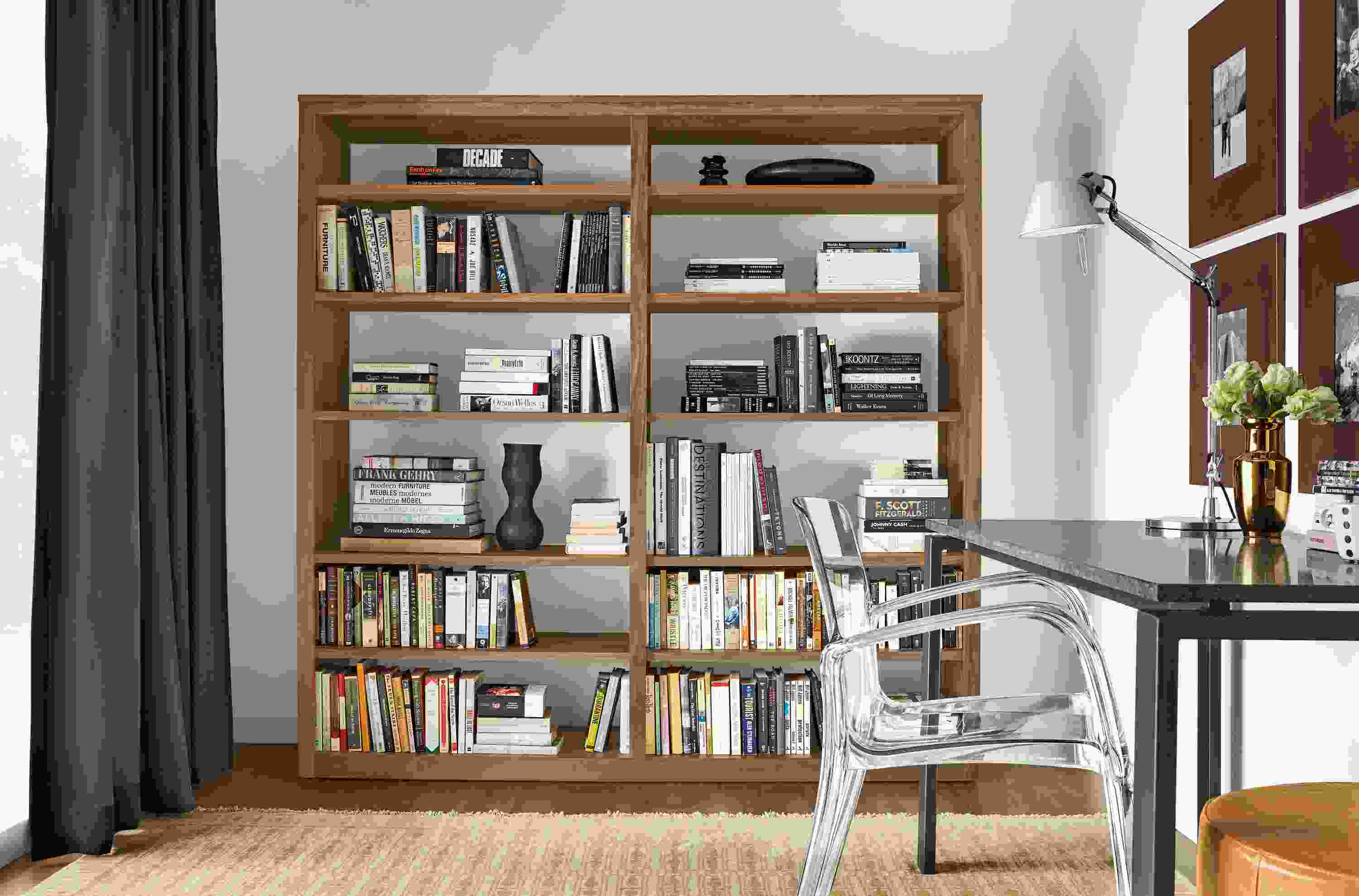 Detail of Woodwind walnut open-back bookcases in walnut and Tulum rug in wheat in a home office.