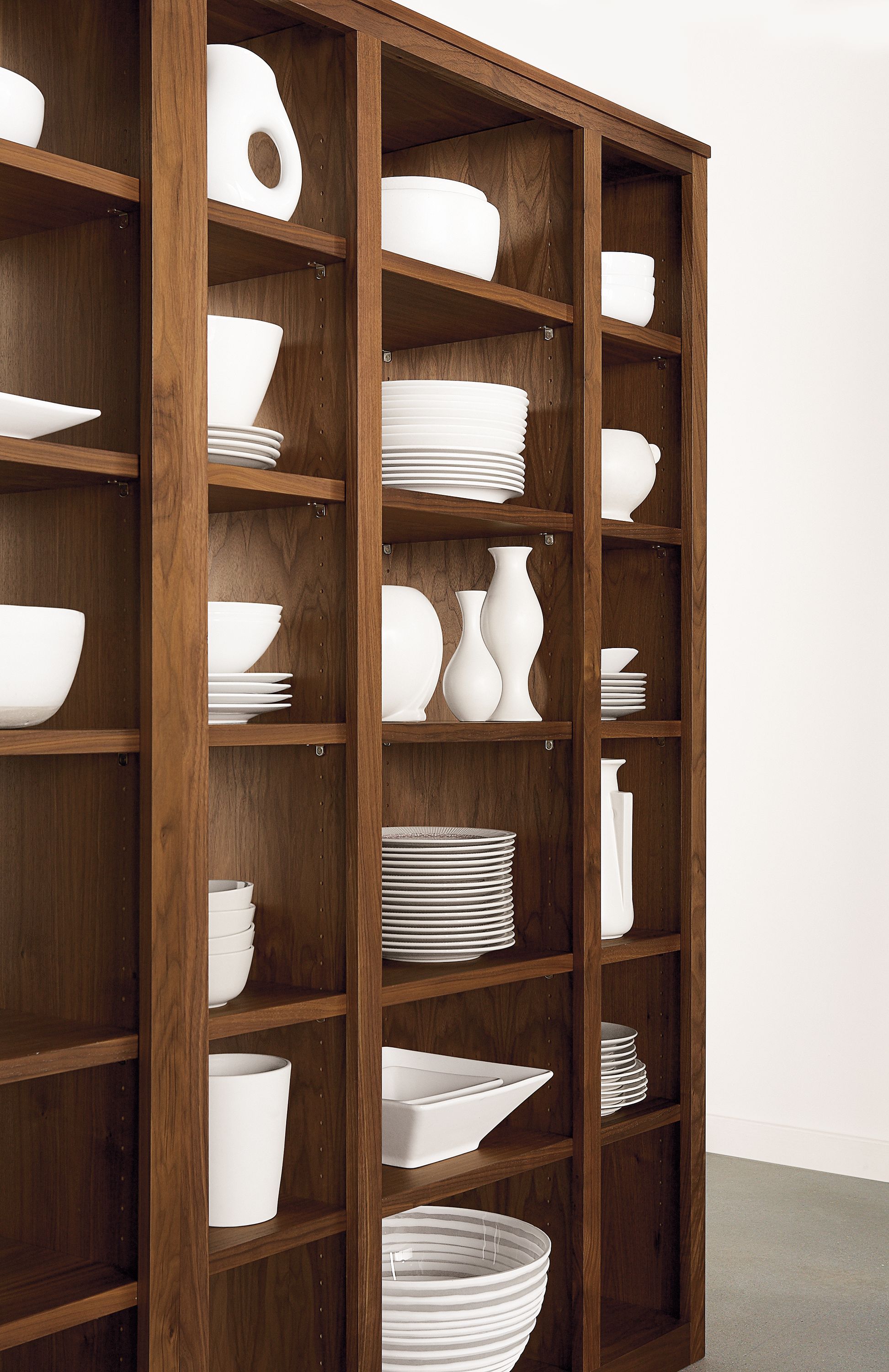 Angled detail of Woodwind 44-wide by 72-high triple open-back bookcase in walnut.