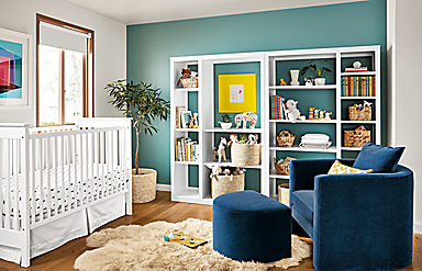 Detail of Woodwind open back bookcases in kids bedroom with Silva chair and Nest crib.
