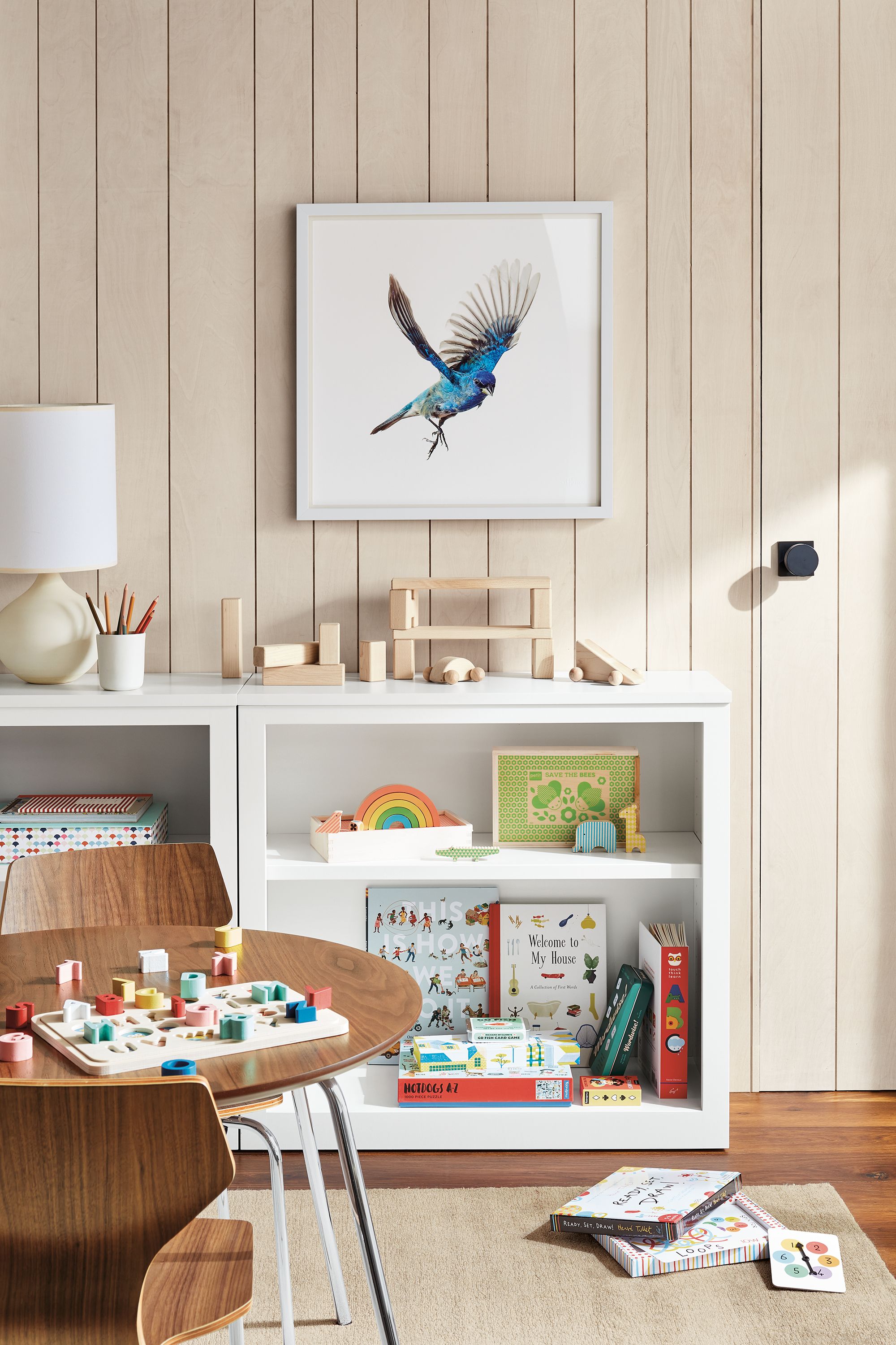 room setting including two woodwind bookcases, perch table, perch chair, impression rug.