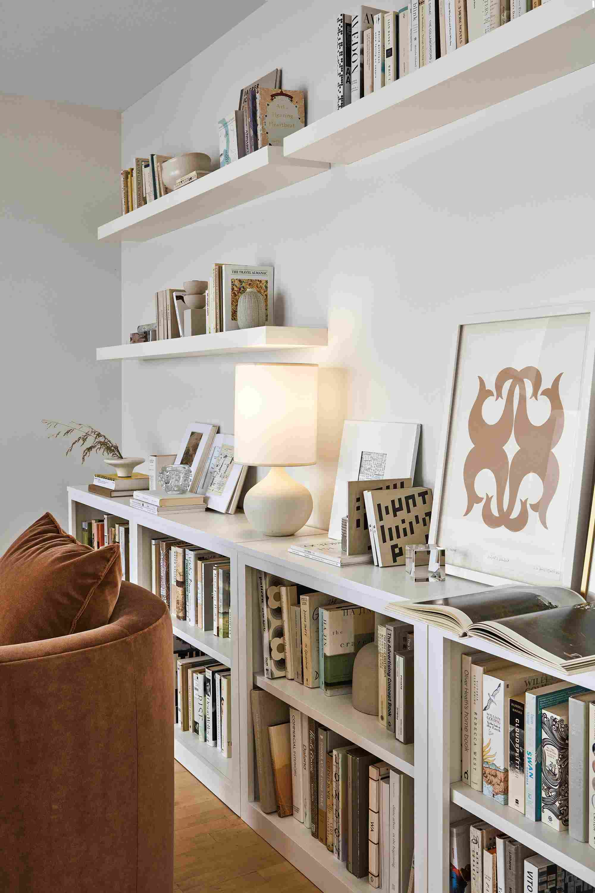 Living room with Woodwind bookcases, float wall shelves, silva chair and simone lamp.