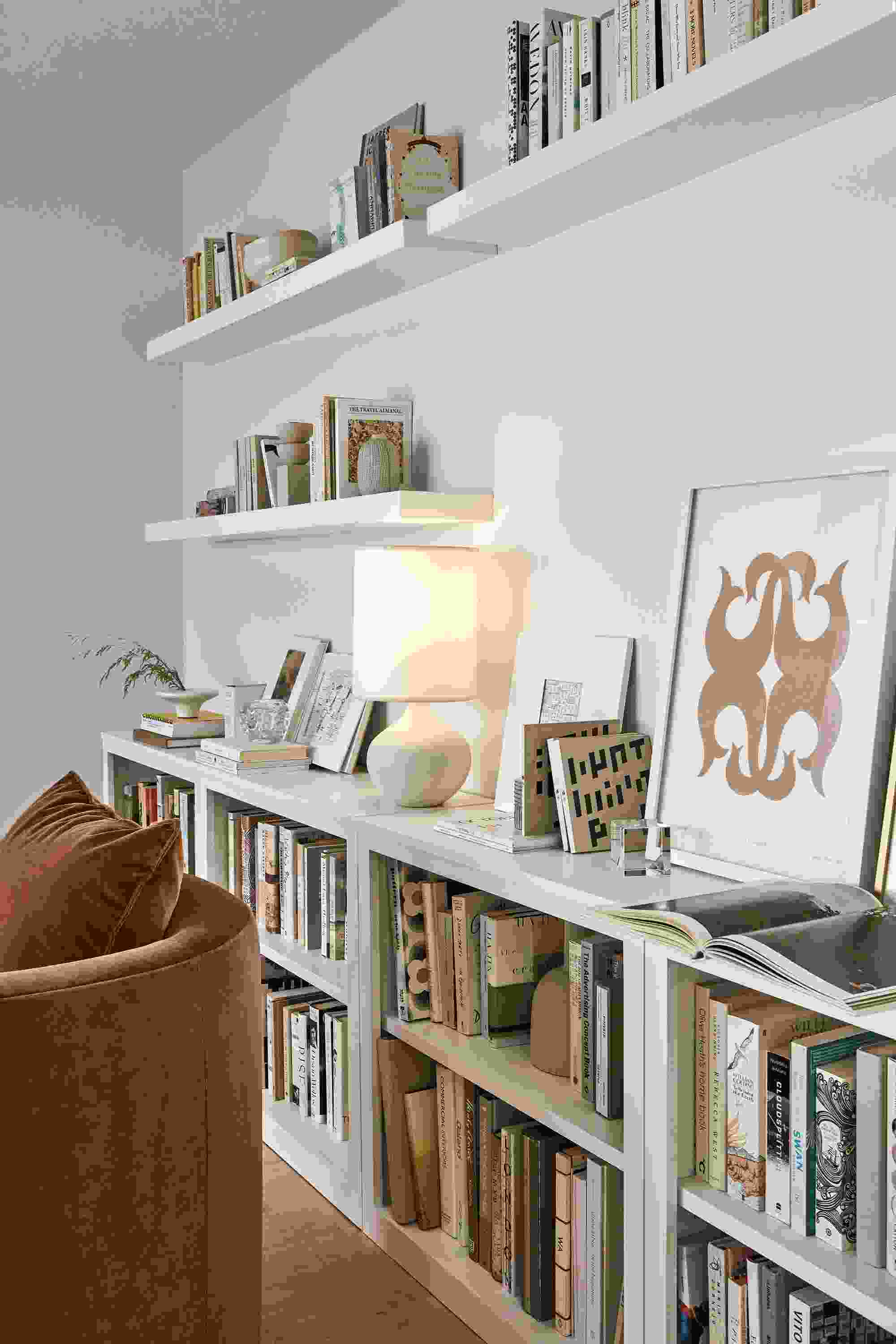 Living room with Woodwind bookcases, float wall shelves, silva chair and simone lamp.