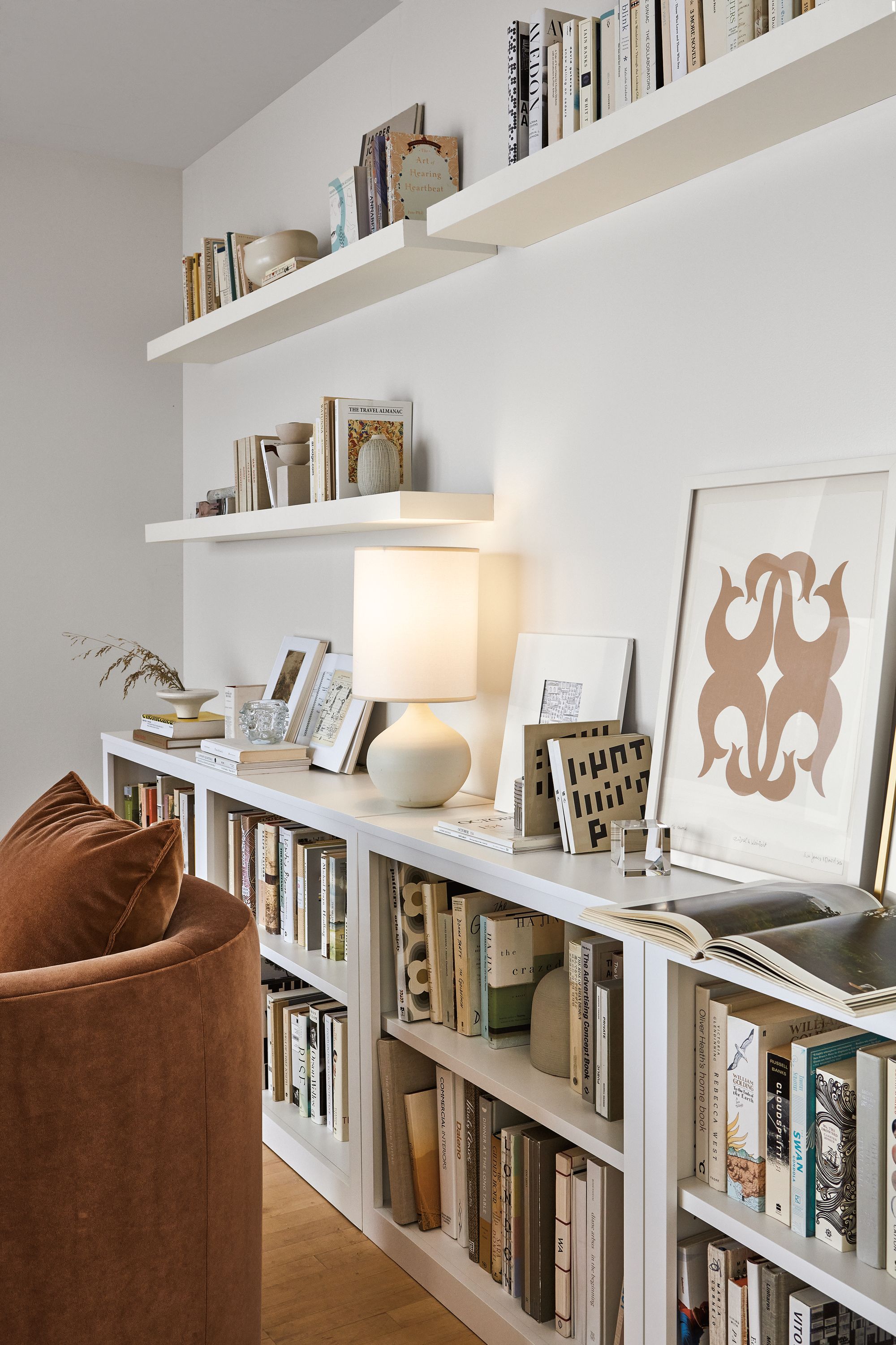 room setting including woodwind bookcases, float wall shelves, silva chair, simone lamp.