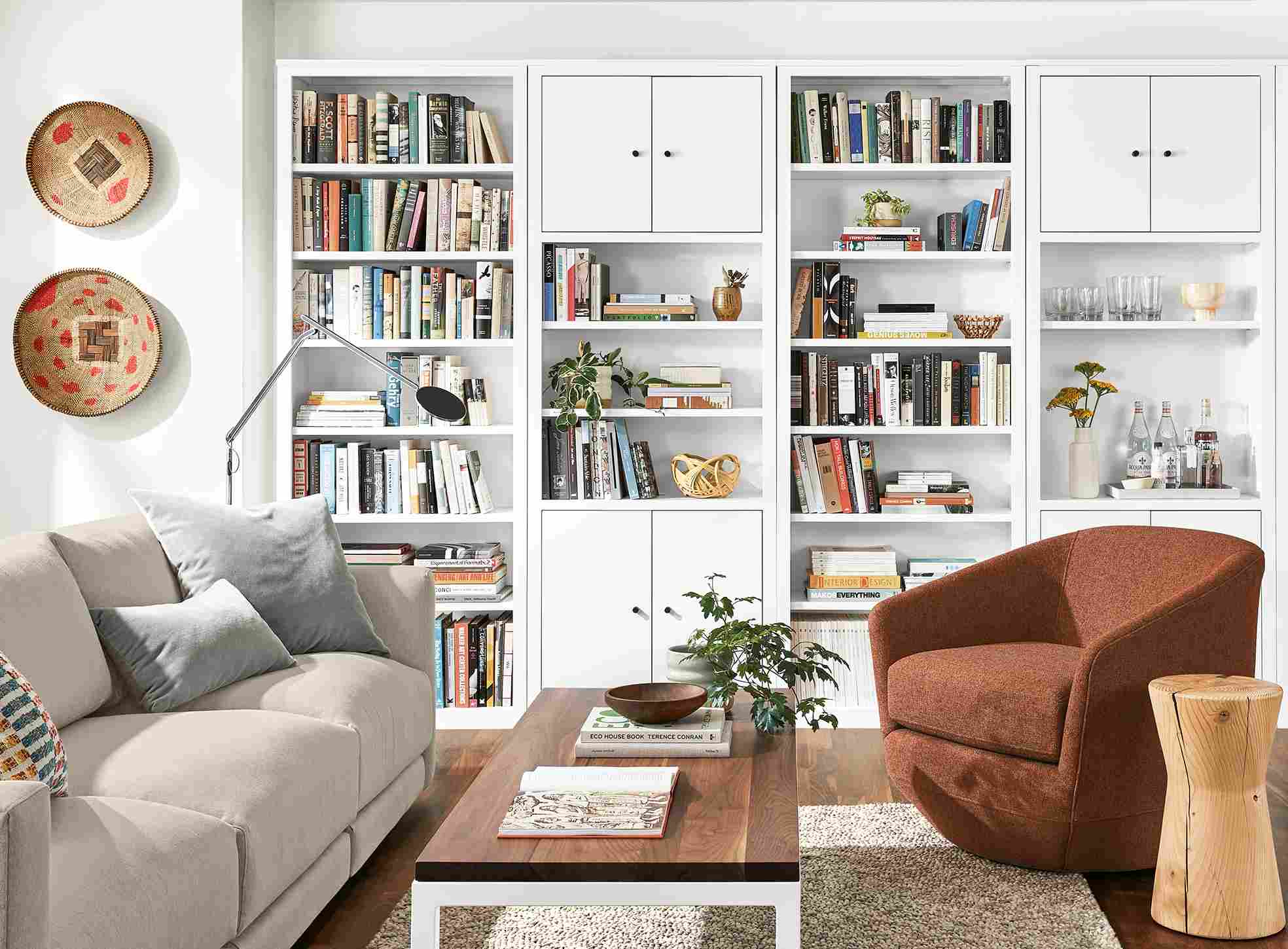 Detail of Woodwind bookcases in white in living room with Gibbs chair and Clemens sofa.