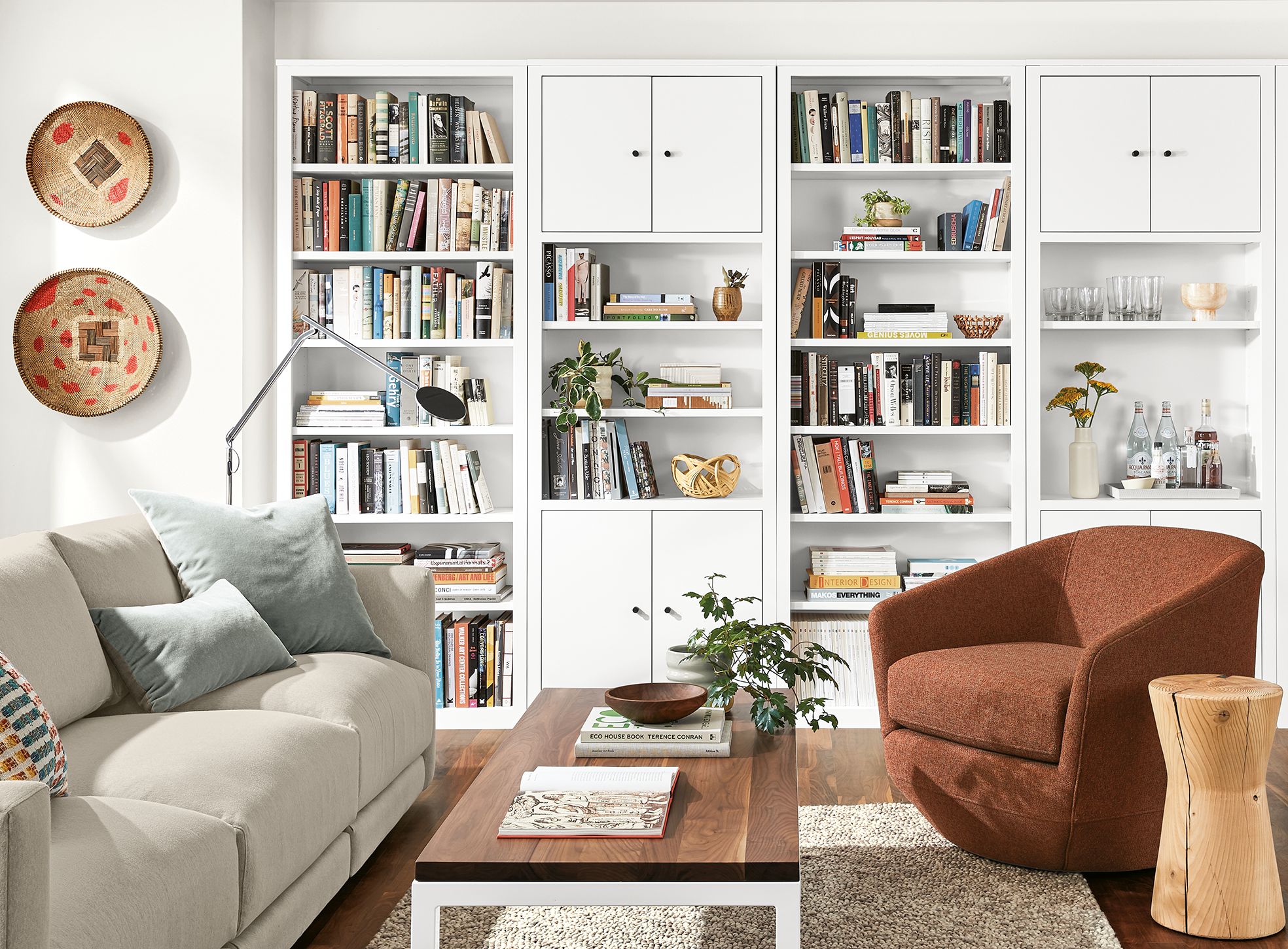 Detail of Woodwind bookcases in white in living room with Gibbs chair and Clemens sofa.