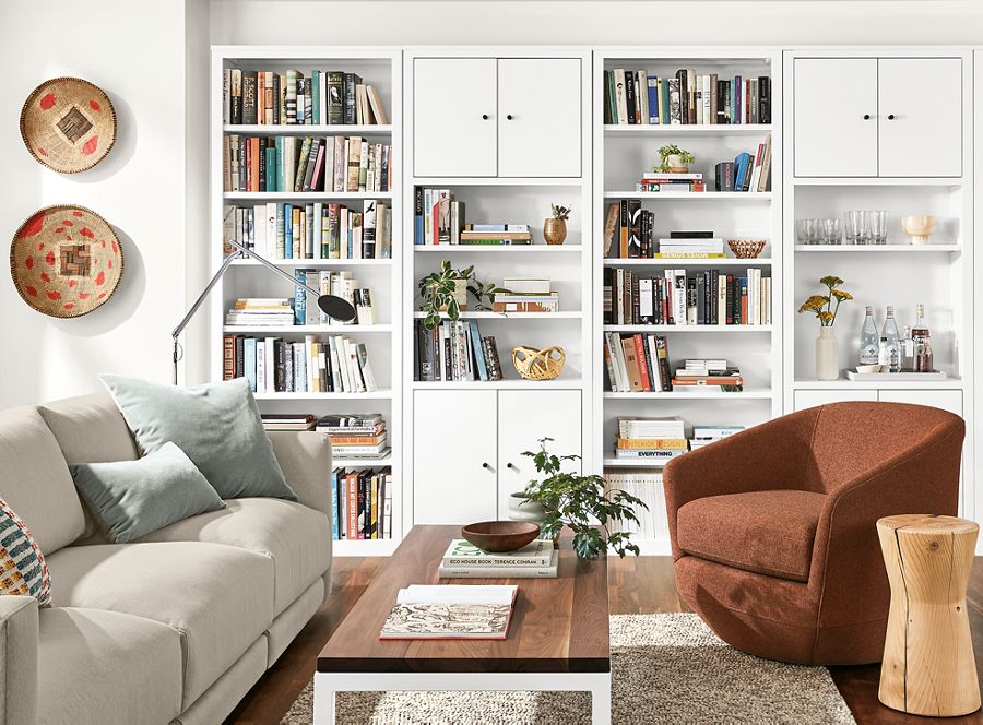 Detail of Woodwind bookcases in white in living room with Gibbs chair and Clemens sofa.