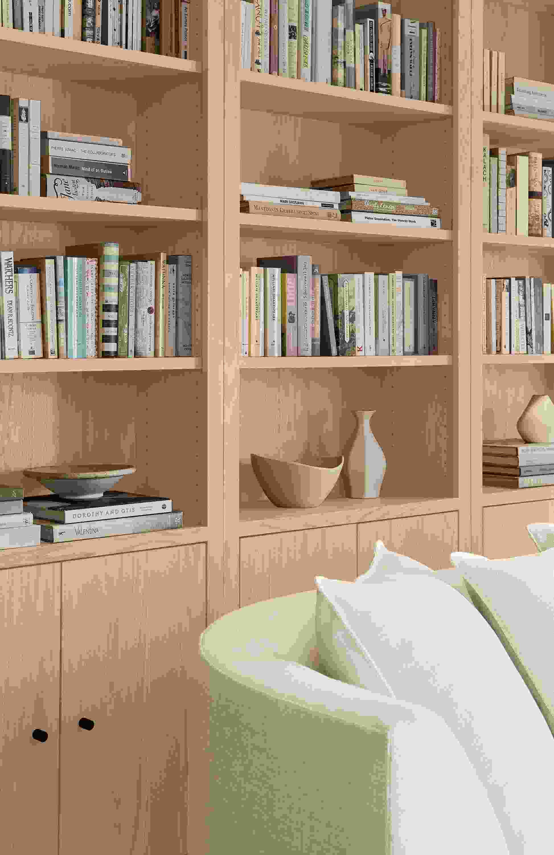 Detail of 3 Woodwind 32-wide two-door bookcase in salt on red oak and astaire 90-wide sofa in sumner ivory.