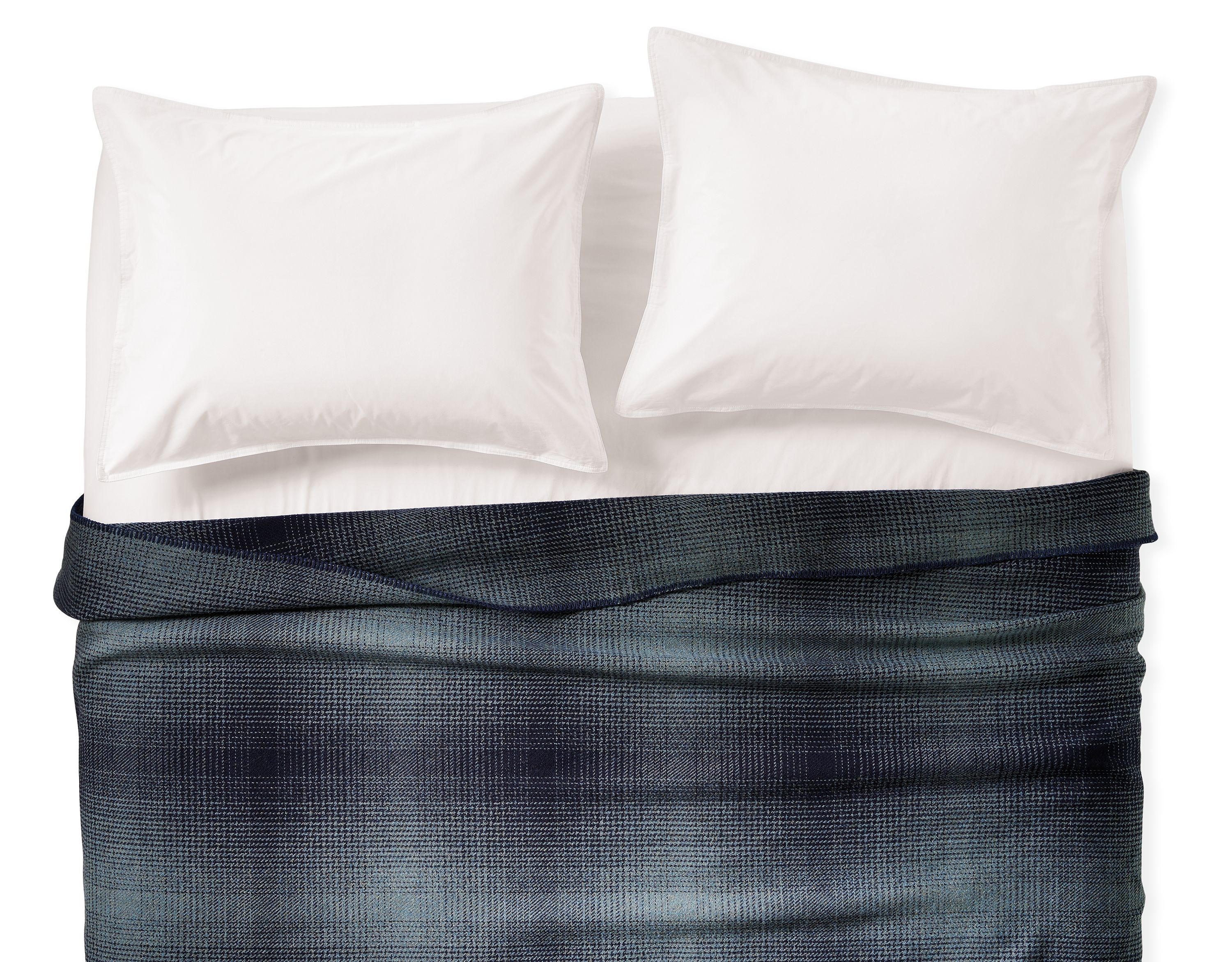 Overhead view of a full/queen blanket in haze ombre plaid and white percale sheets and shams.