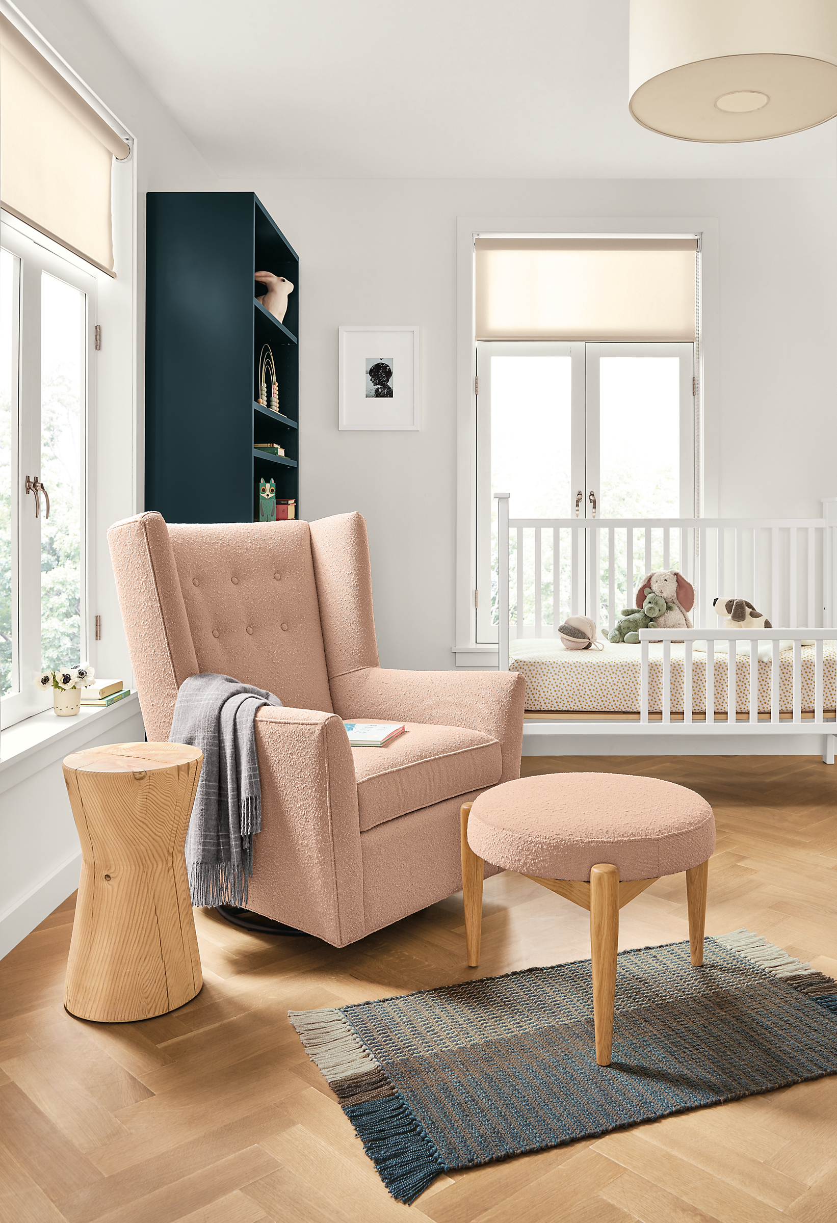 Detail of Wren swivel glider chair in Declan Blush fabric in baby's room.