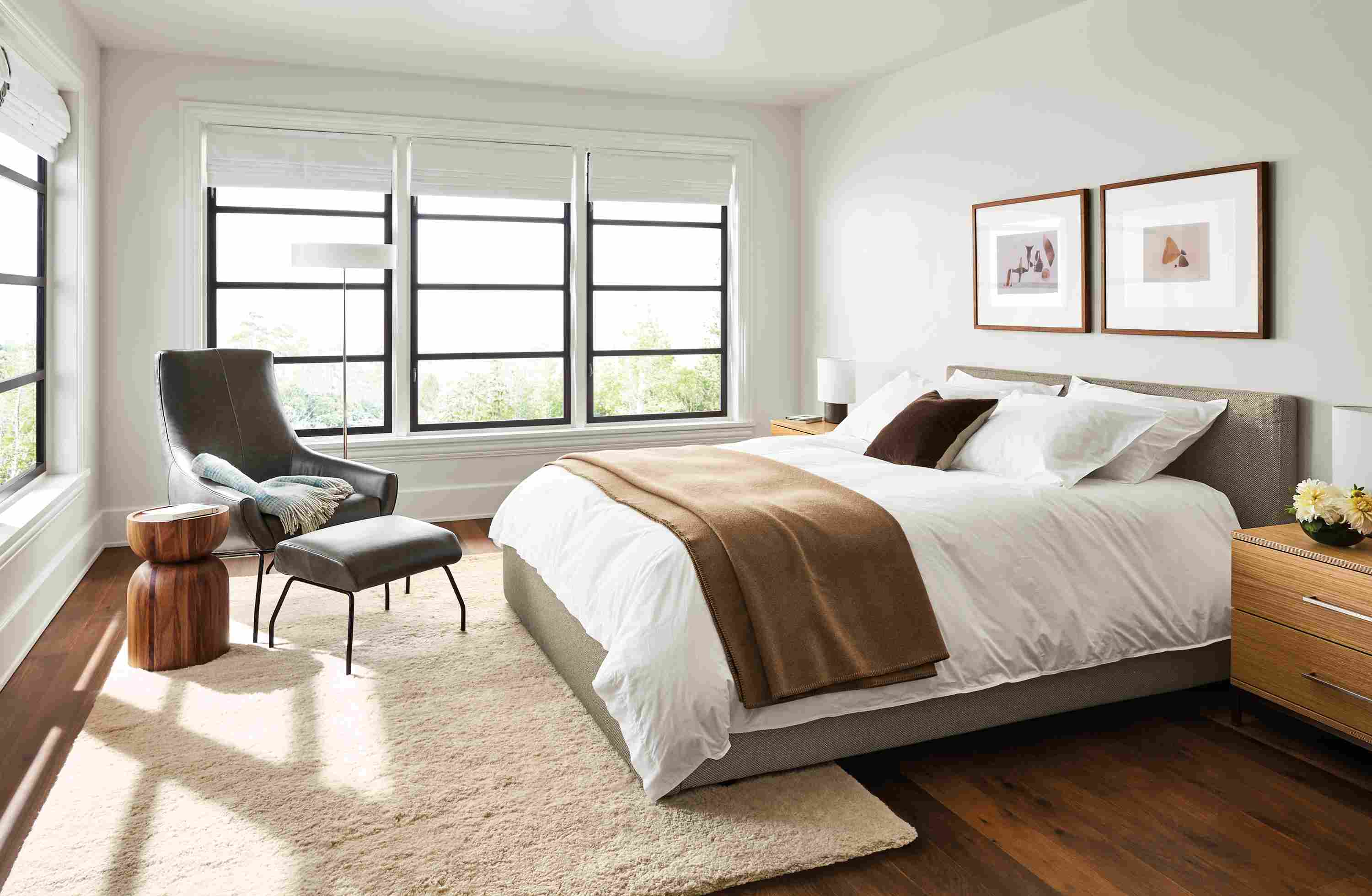 Bedroom with Wyatt queen bed in Arin Grey, Baker nightstands in white oak and Rhodes lounge chair in Vento Smoke.