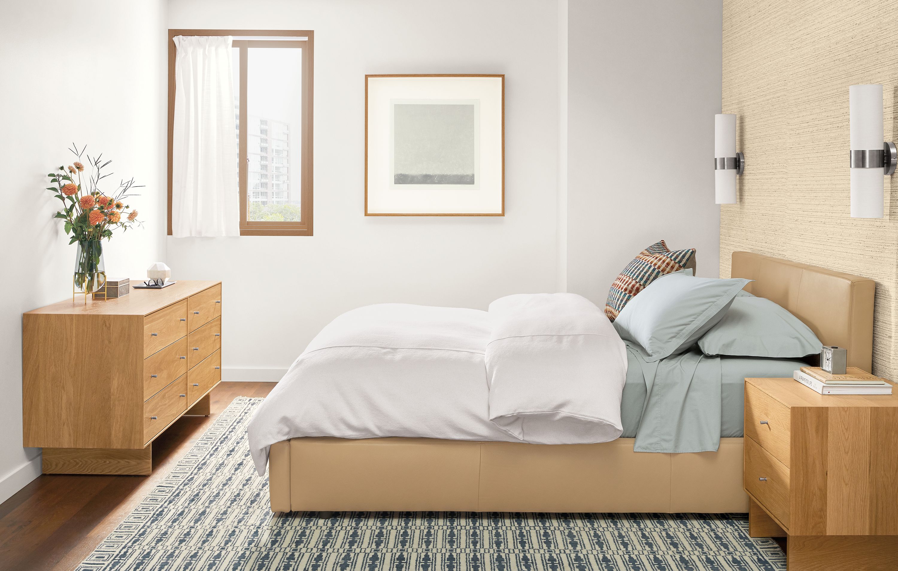Bedroom with wyatt queen storage bed in fiero camel leather, hudson dresser and nightstand in white oak.