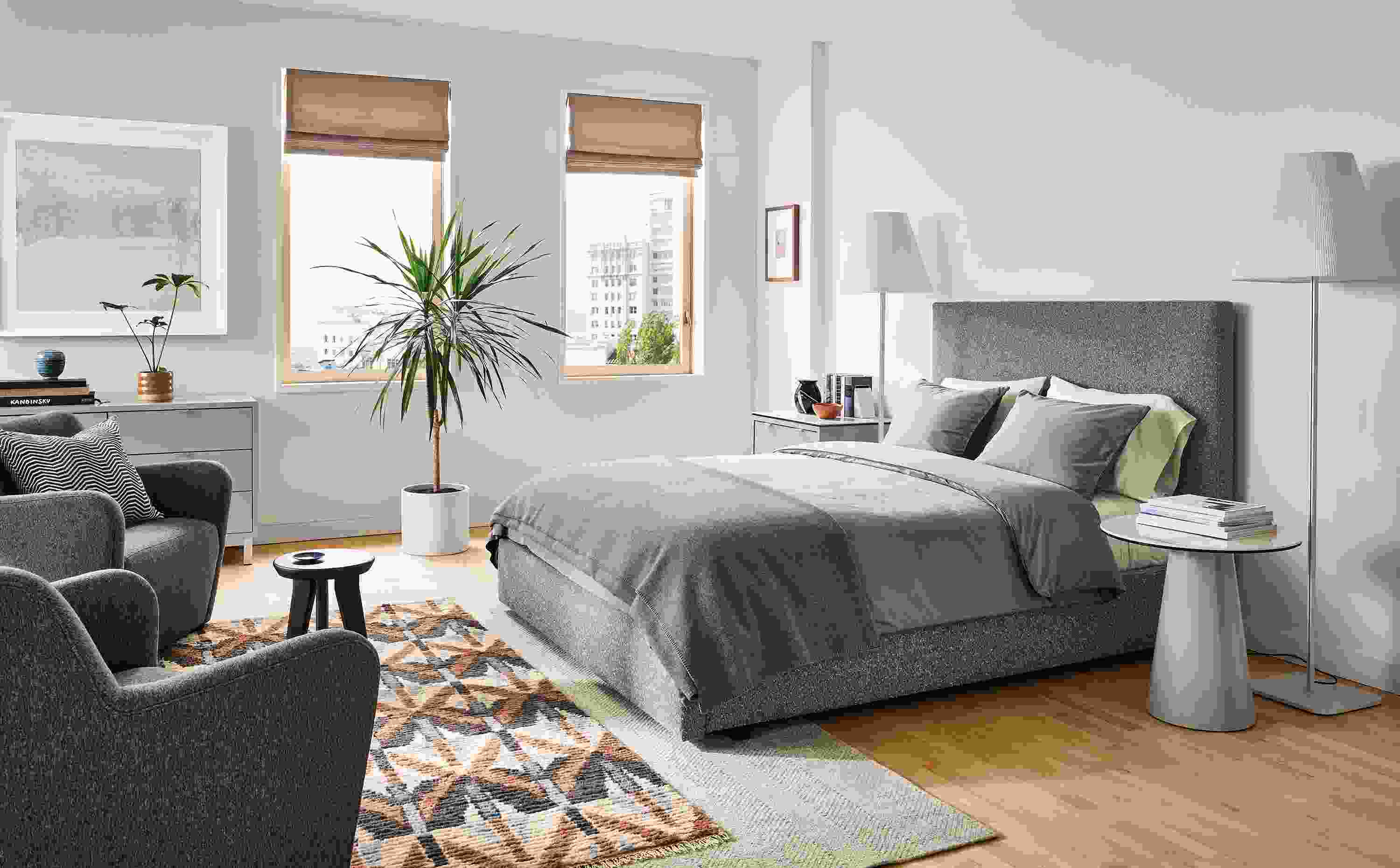 Bedroom with Wyatt queen storage bed in Conley Graphite, Lily chairs, Barlow floor lamps.
