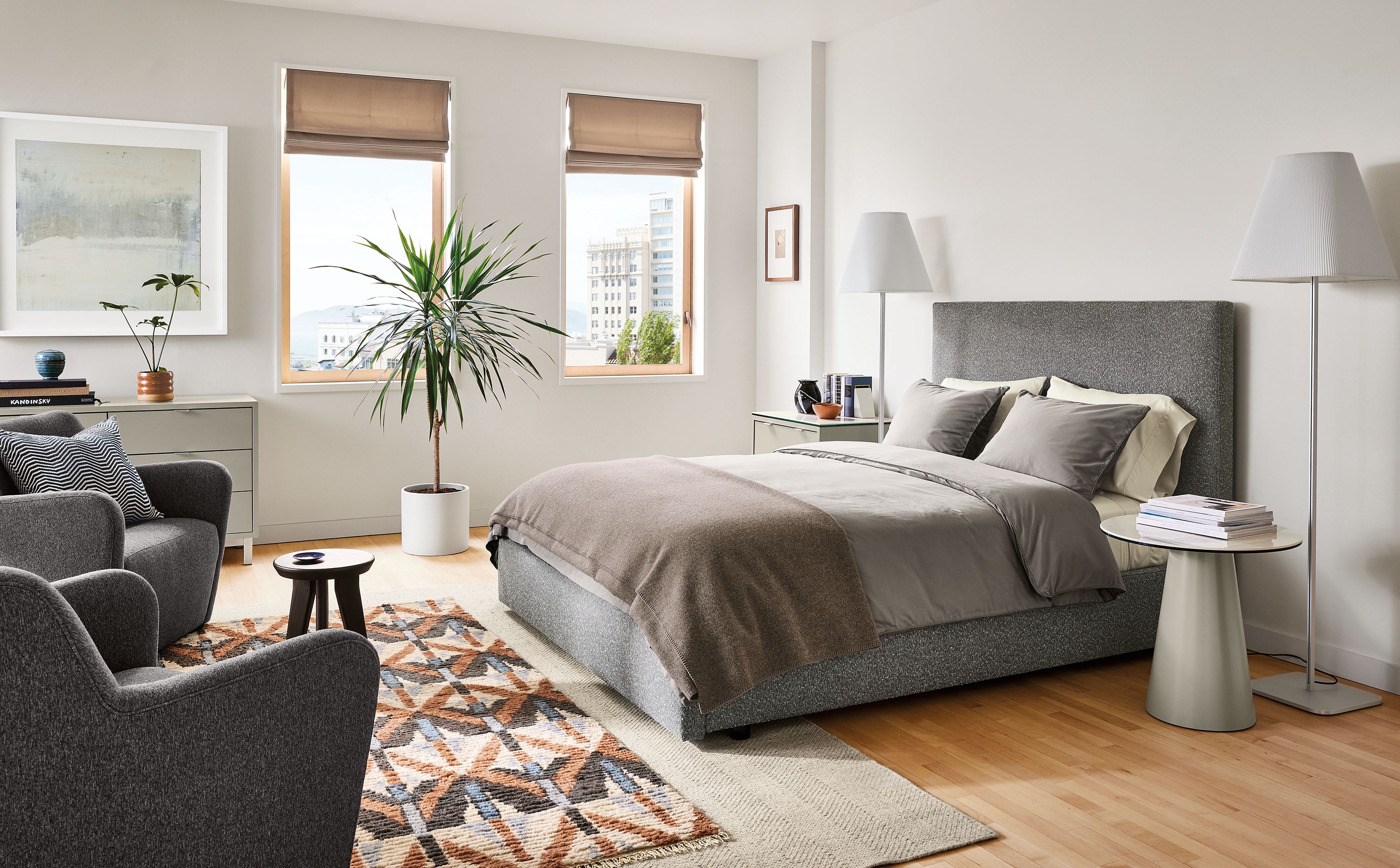 bedroom with wyatt queen storage bed in conley fabric, lily chairs, barlow floor lamps.