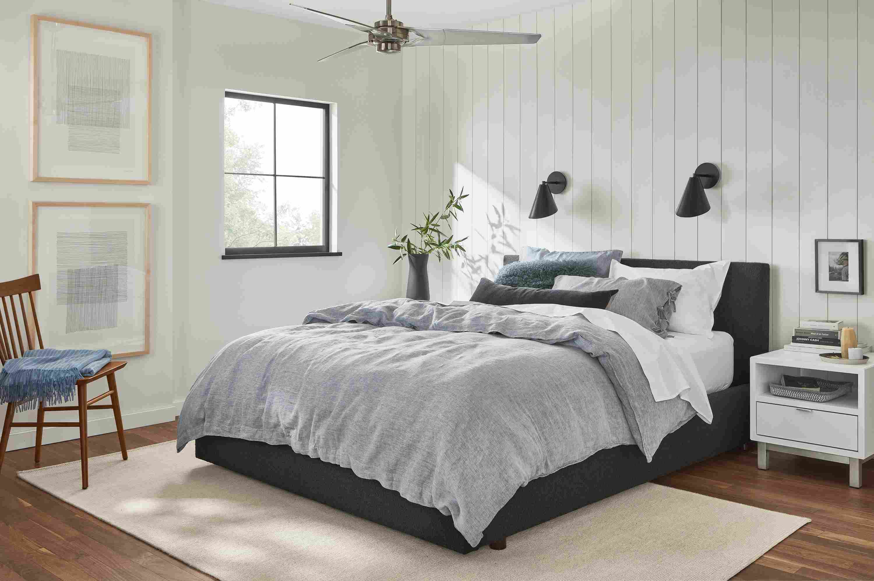 Bedroom with Wyatt queen bed in Declan Graphite with relaxed linen bedding in blue chambray.