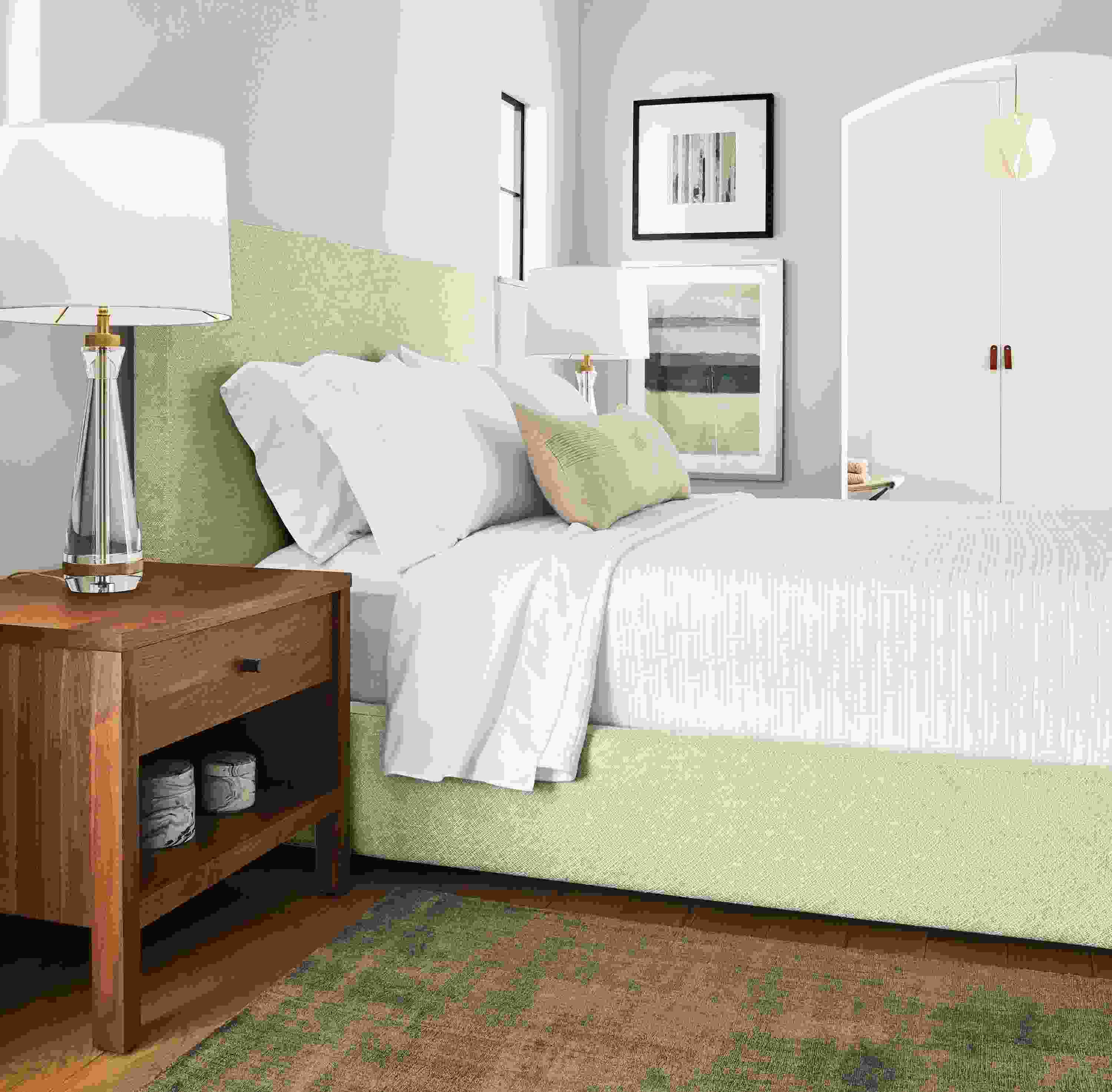 Bedroom with detail of Wyatt queen storage bed in Garett Oatmeal and Emerson nightstand in walnut.