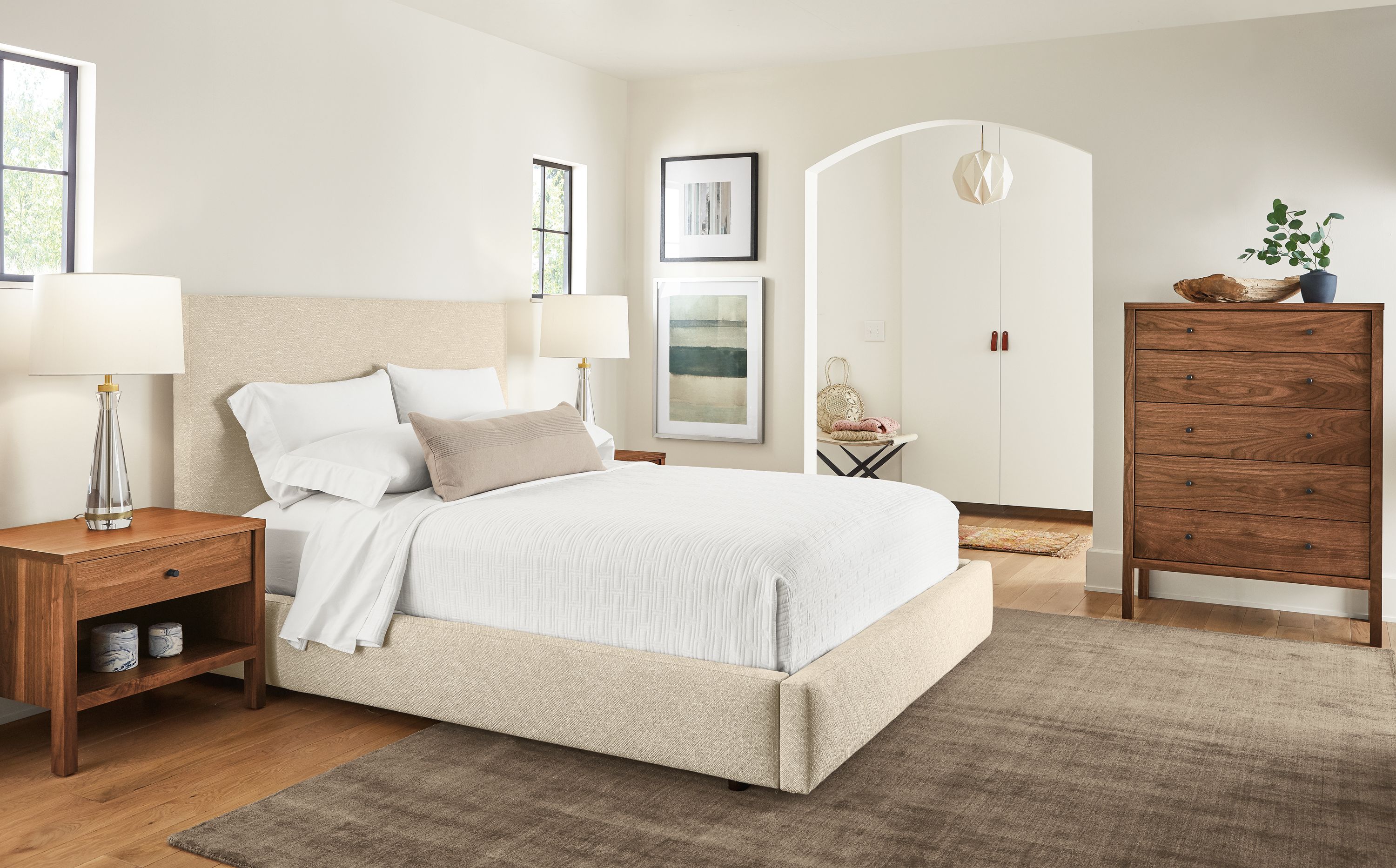 Bedroom with Wyatt queen storage bed in Garret Oatmeal and Emerson dresser and nightstands in walnut.