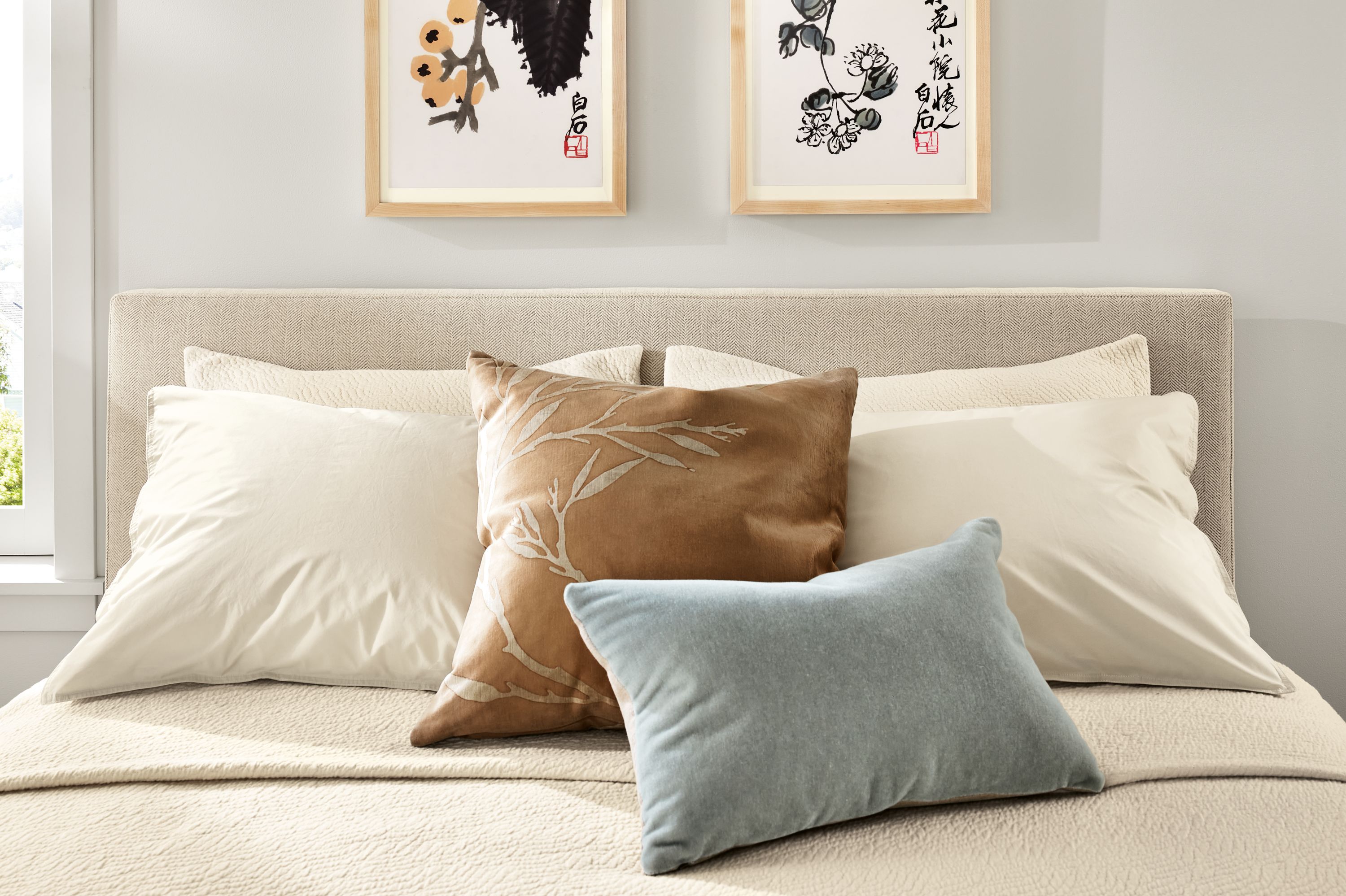 Bedroom with Wyatt bed in frond natural with Thea bedding and signature percale sheets in ecru.