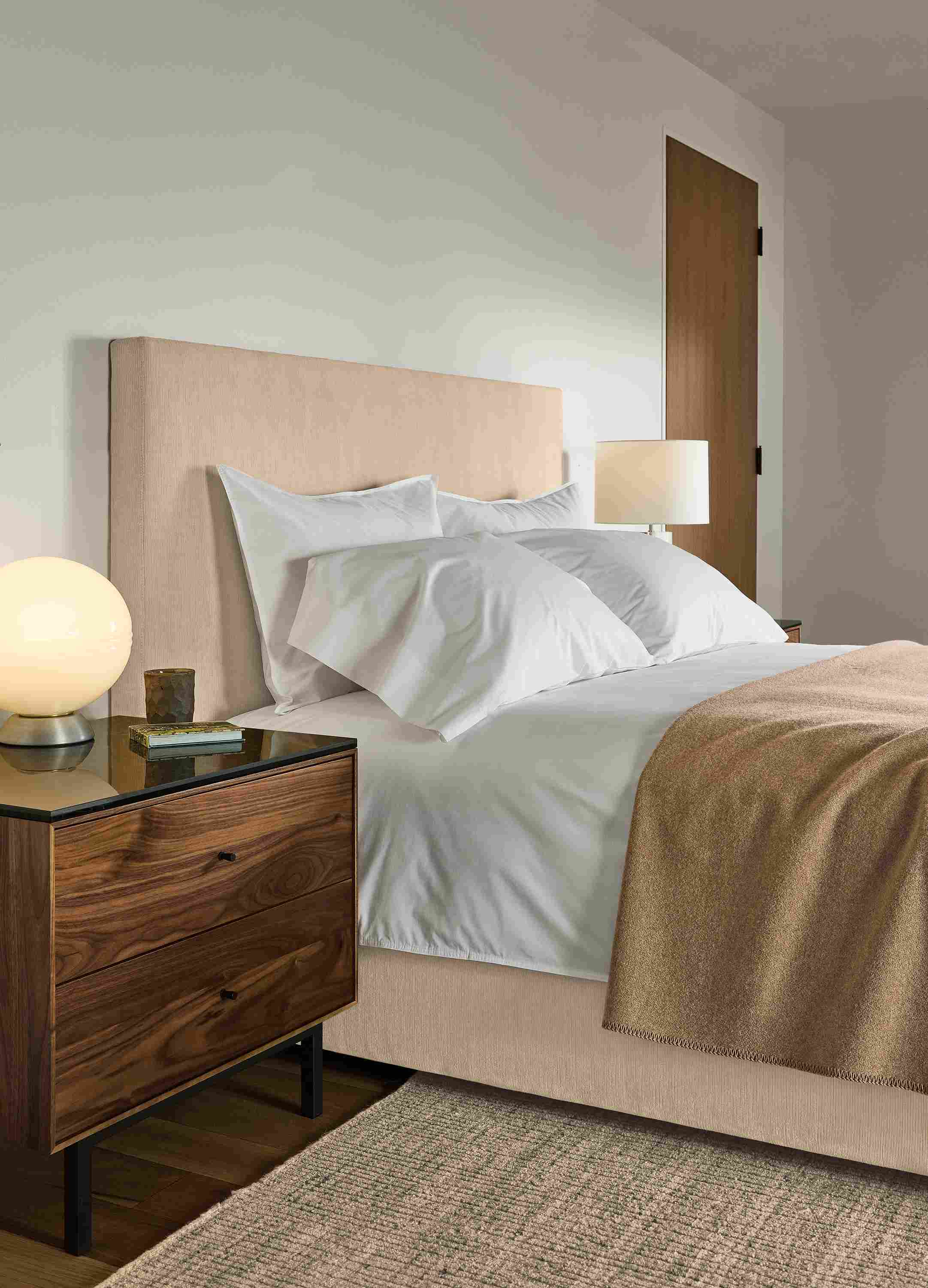 Bedroom with Wyatt queen bed in Nigel Natural and Hudson 2-drawer nightstand in graphite and Marbled black ceramic top.