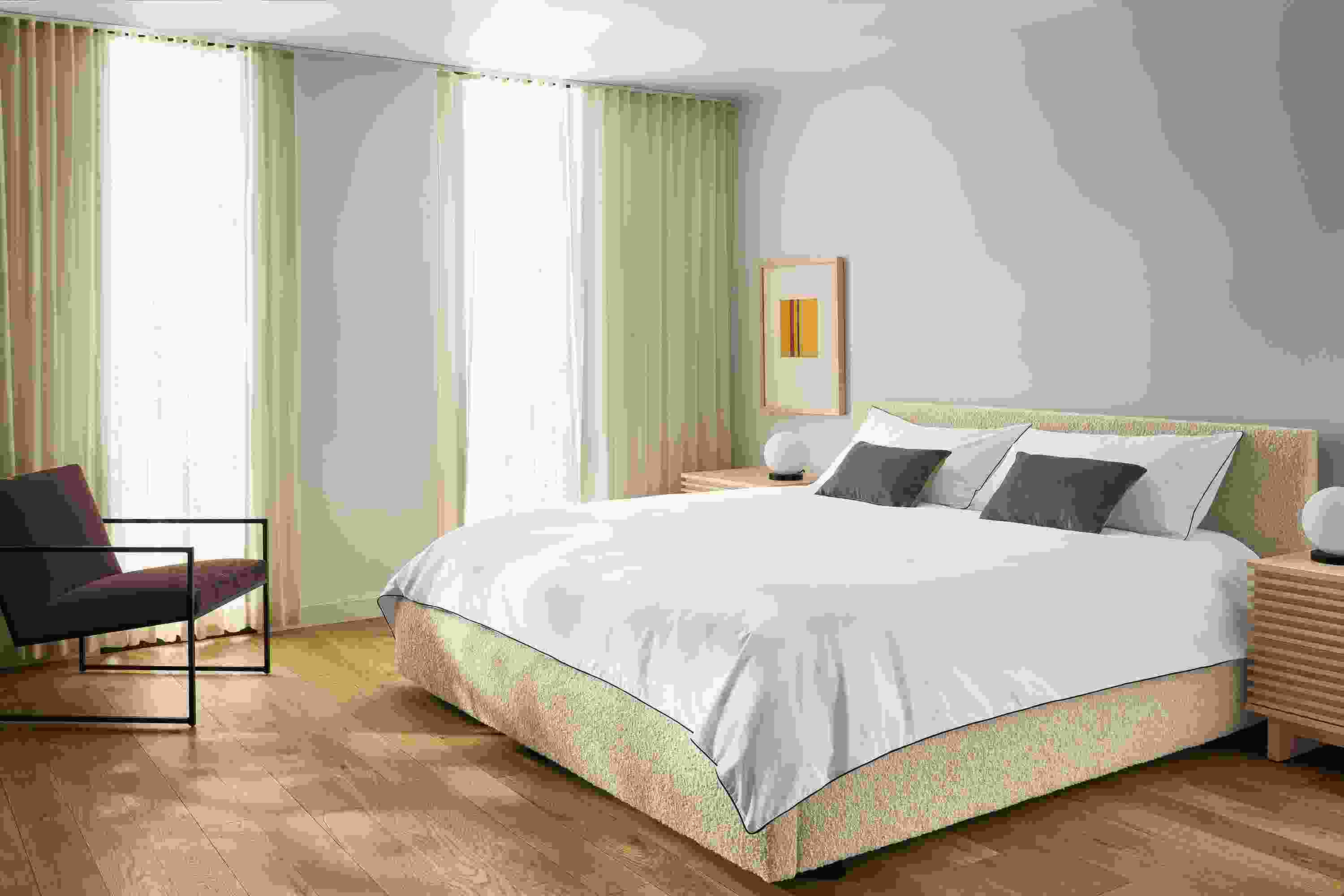 Bedroom with Wyatt king bed in Dornick Ivory, 2 Coles nightstands in salt on red oak and Novato chair in Redding Espresso.