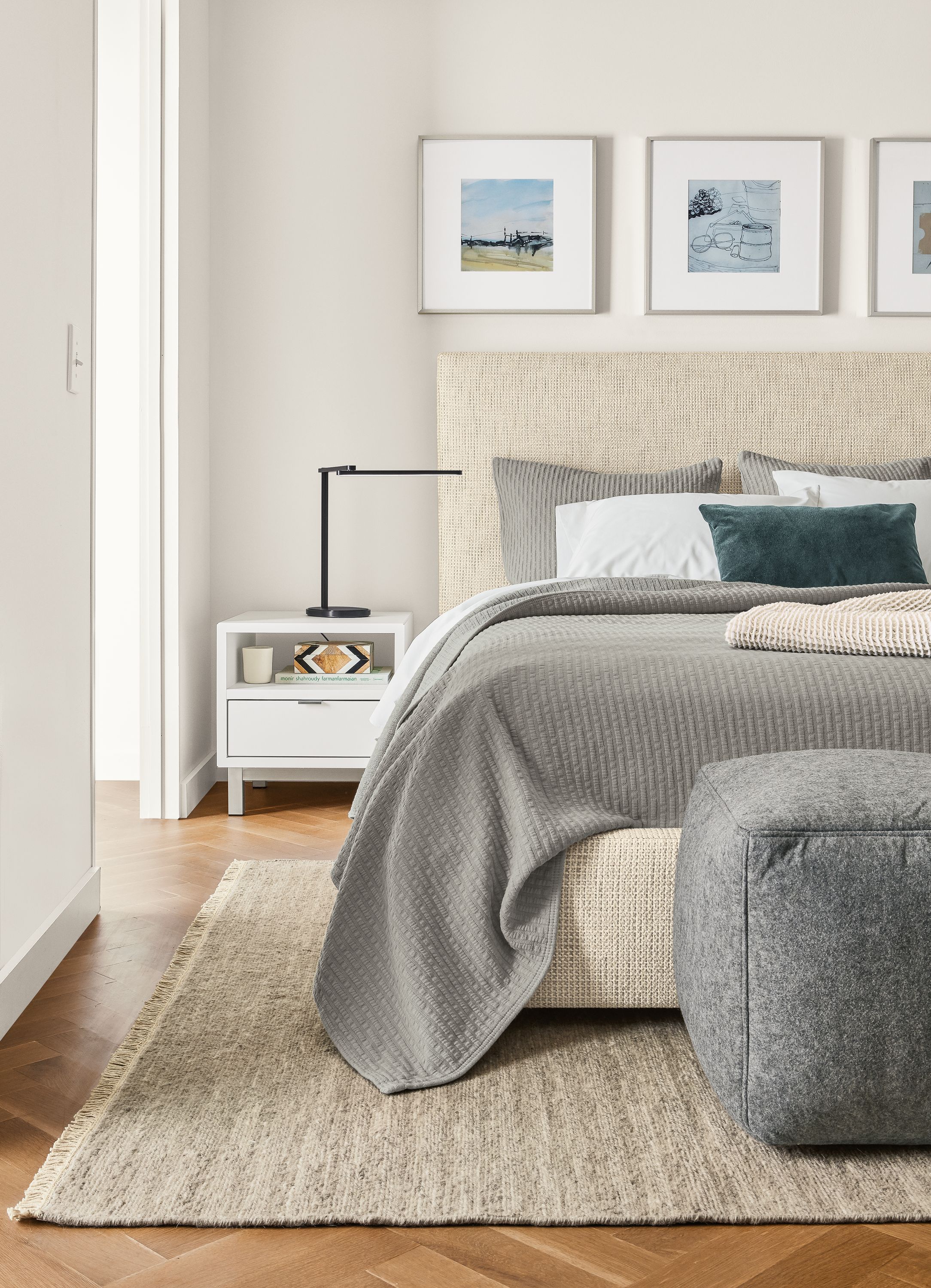 Bedroom with Wyatt queen storage bed in Hearth Oyster fabric and Copenhagen nightstand in white.