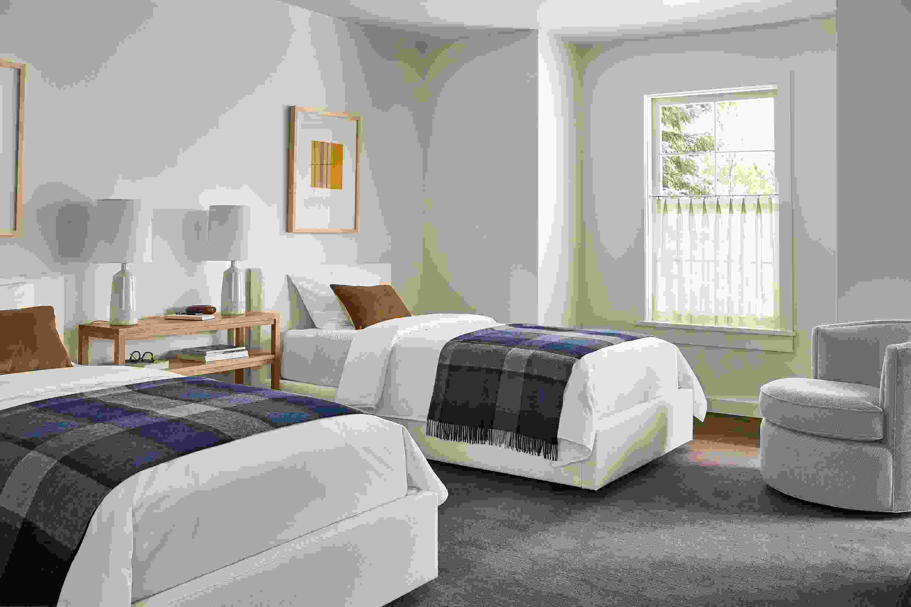 Bedroom with 2 Wyatt twin beds in Sumner Ivory and an Otis swivel chair in Derry Cement.