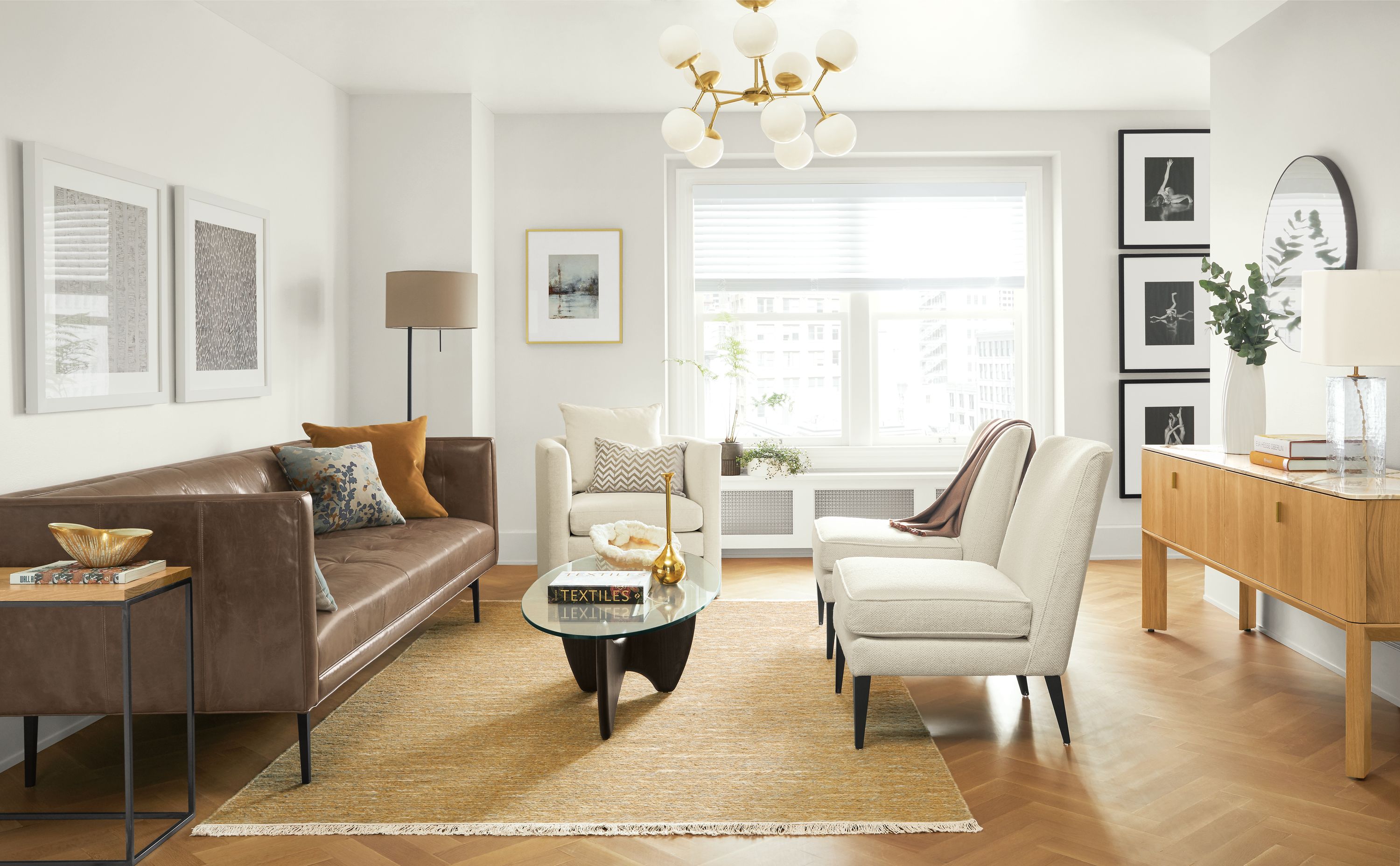 Detail of Wynwood sofa in Vento Pewter leather in living room with Pren console cabinet.