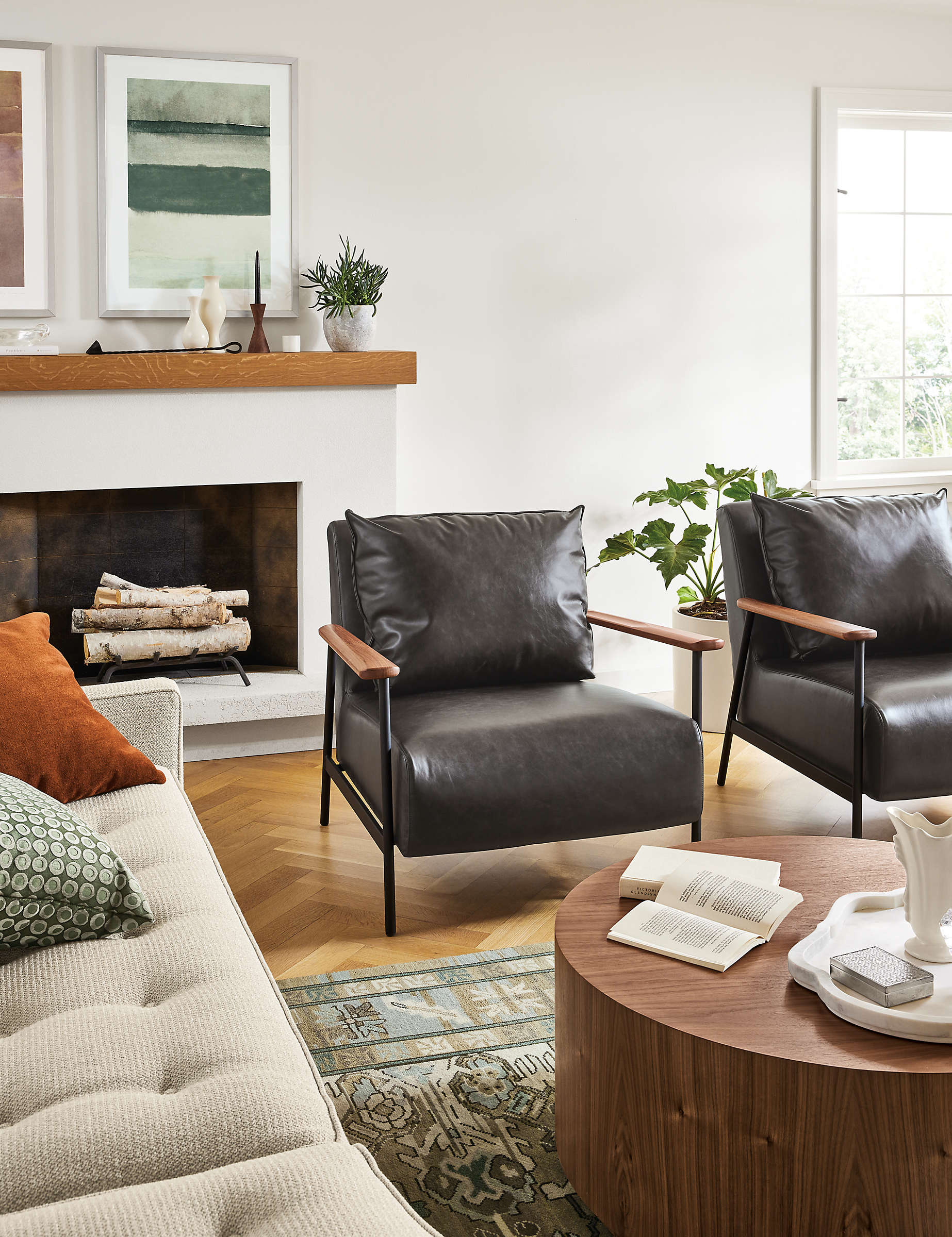 Living room with 2 Xavier chairs in Palermo Charcoal, Liam 36-inch coffee table in walnut, and Reese sofa in Orla Ivory.