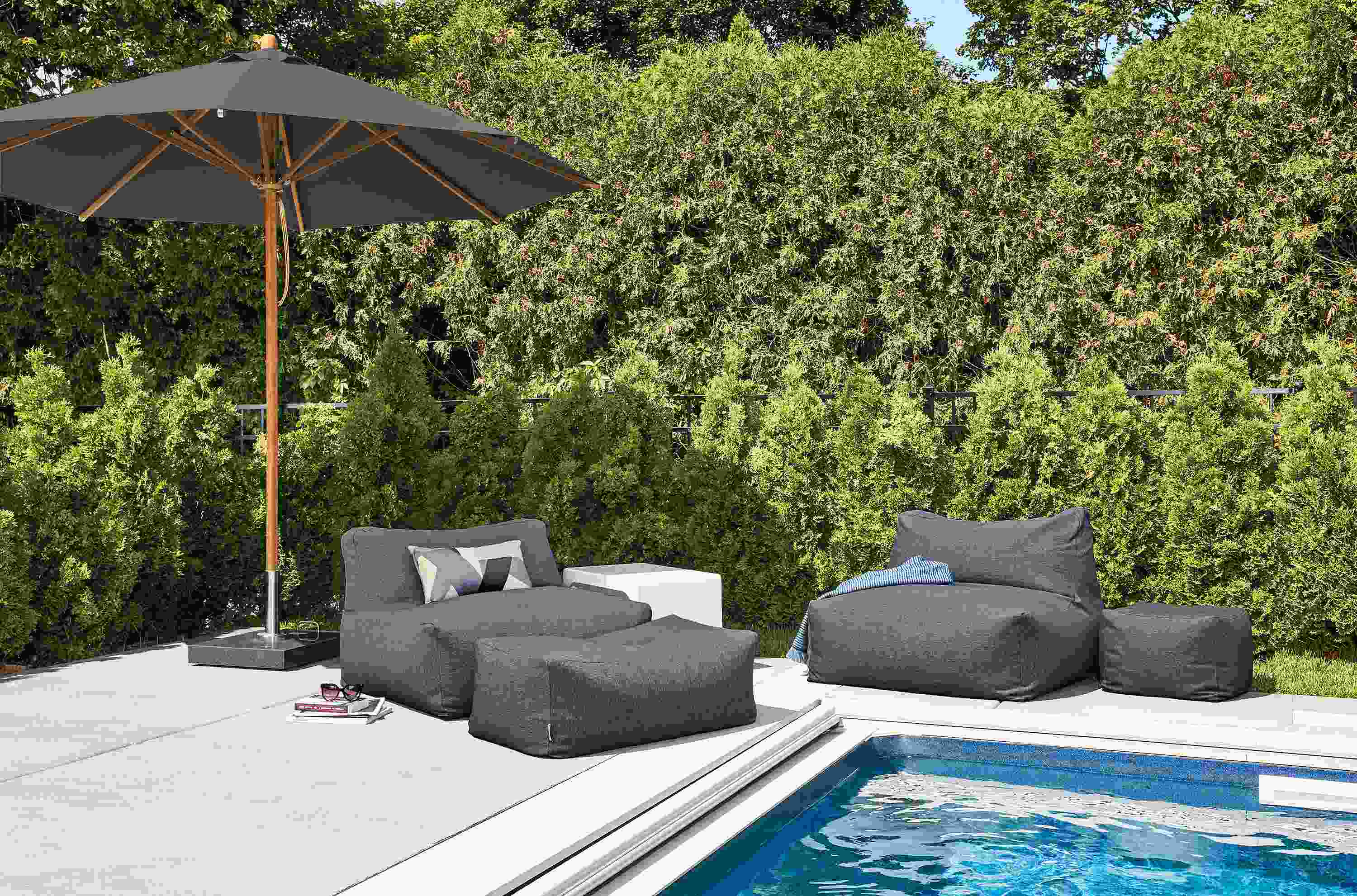 Poolside detail of Yamba chairs, ottoman and pouf  in Mist Navy fabric.