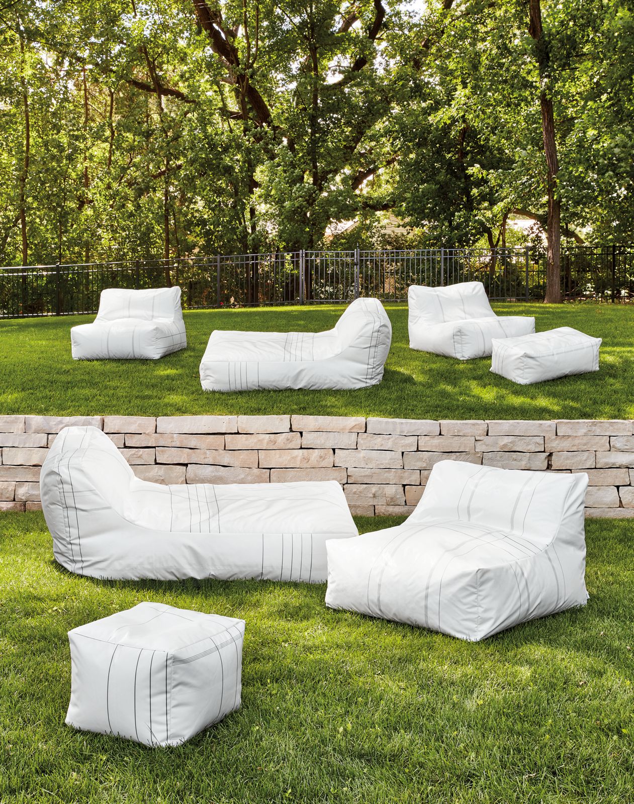Yamba chair, poufs, ottomans, chaise and round bean bag in Upcycled Airbag material in outdoor setting.