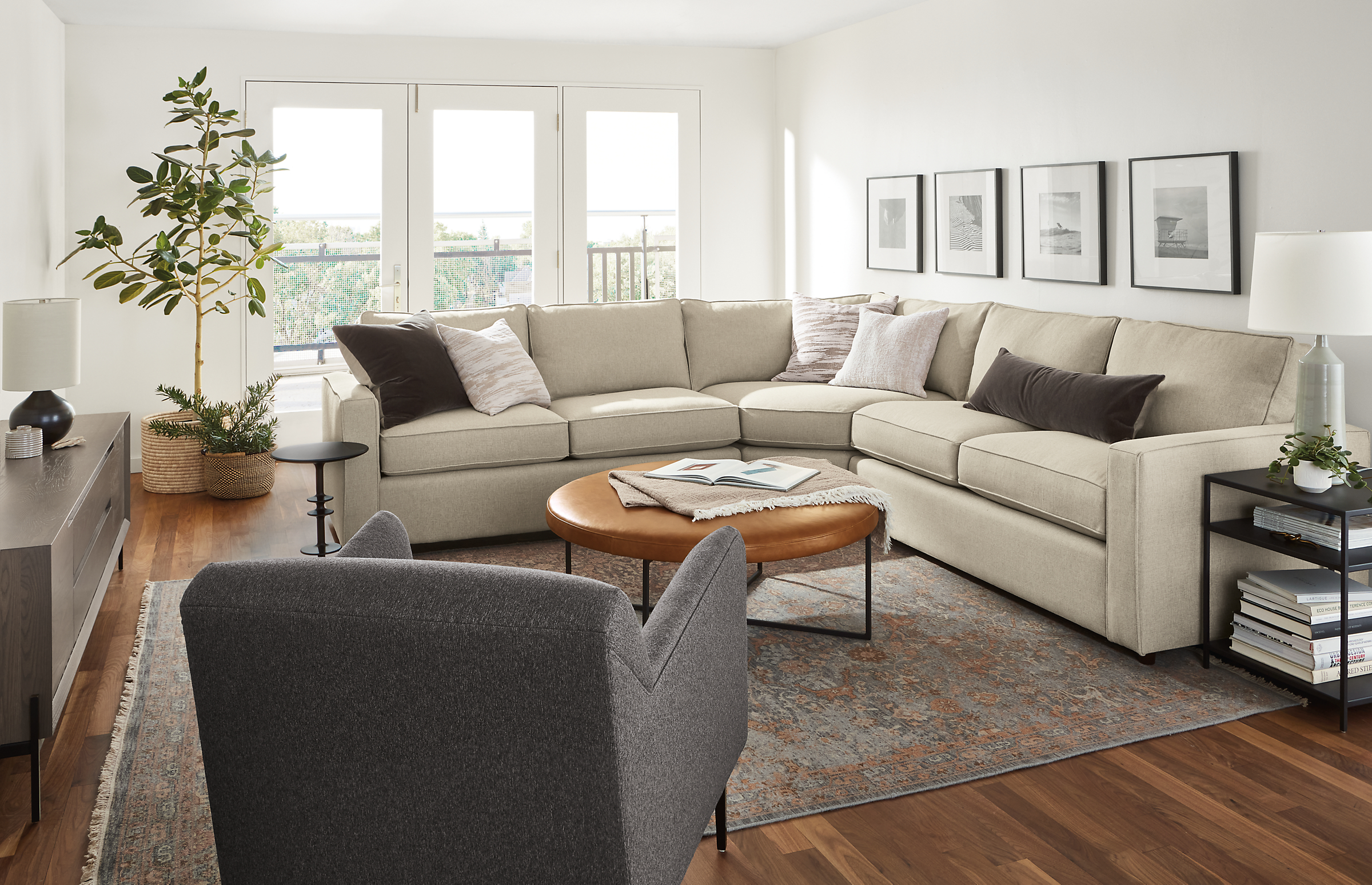 room setting including york 3-piece sectionals, matteo chair, kinley media cabinet, vesuvio rug.