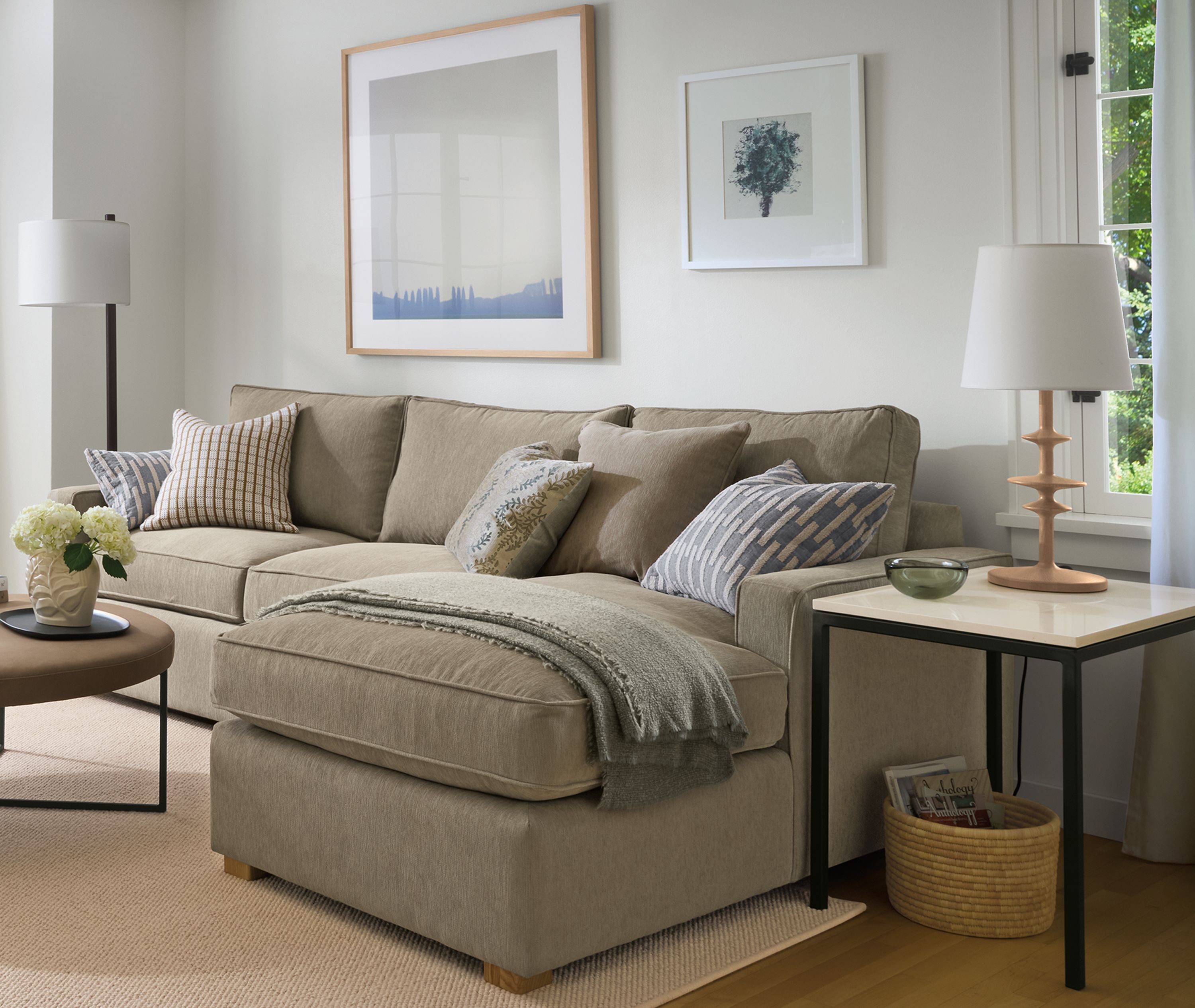 Living room with York sofa in Crawford Putty, Sonja swivel chair in Caldwell Olive and Flannery rug in Oatmeal.