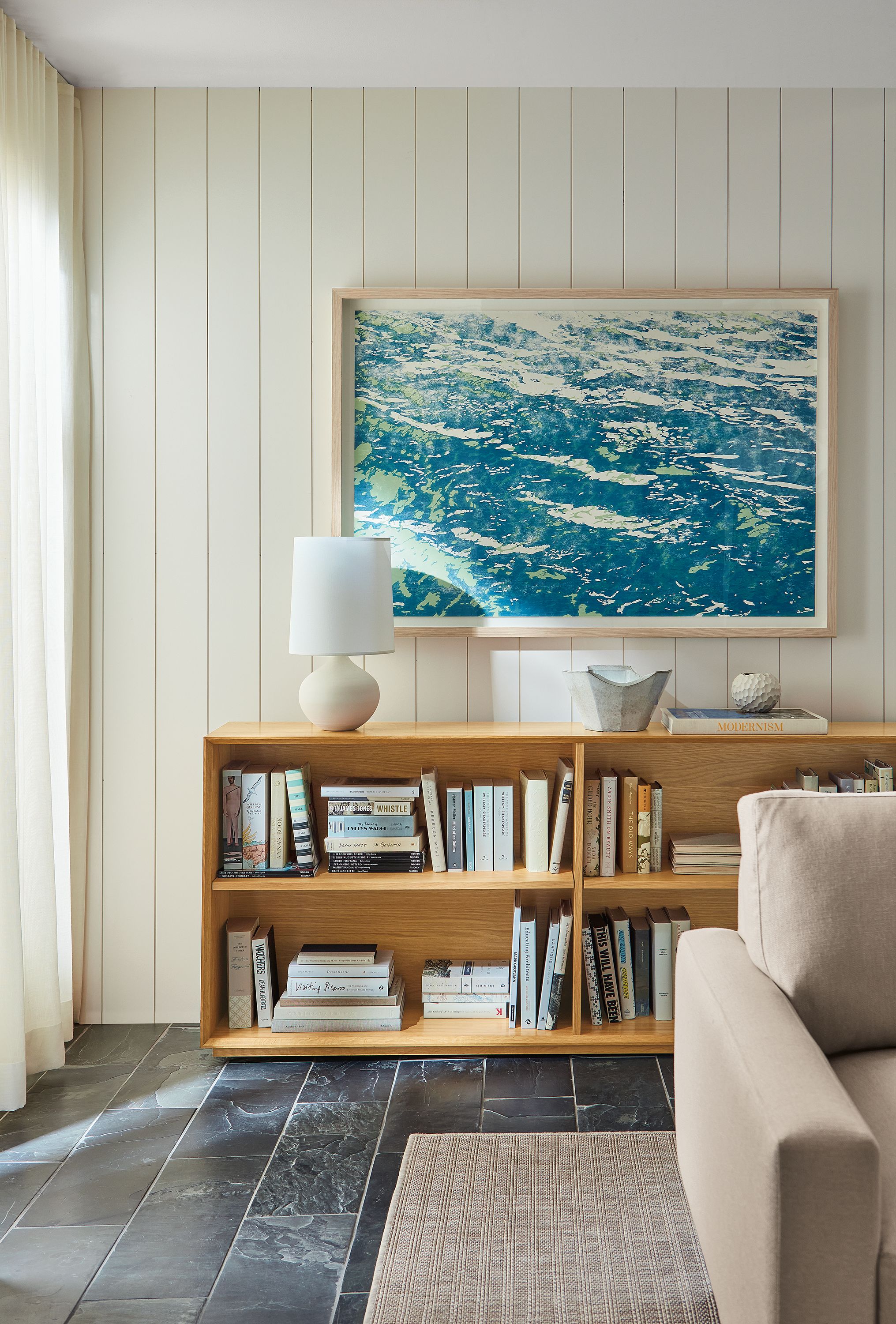 Living room with Ayomi Yoshida, Water Surface Lake Green artwork and rollins console bookcase in white oak.