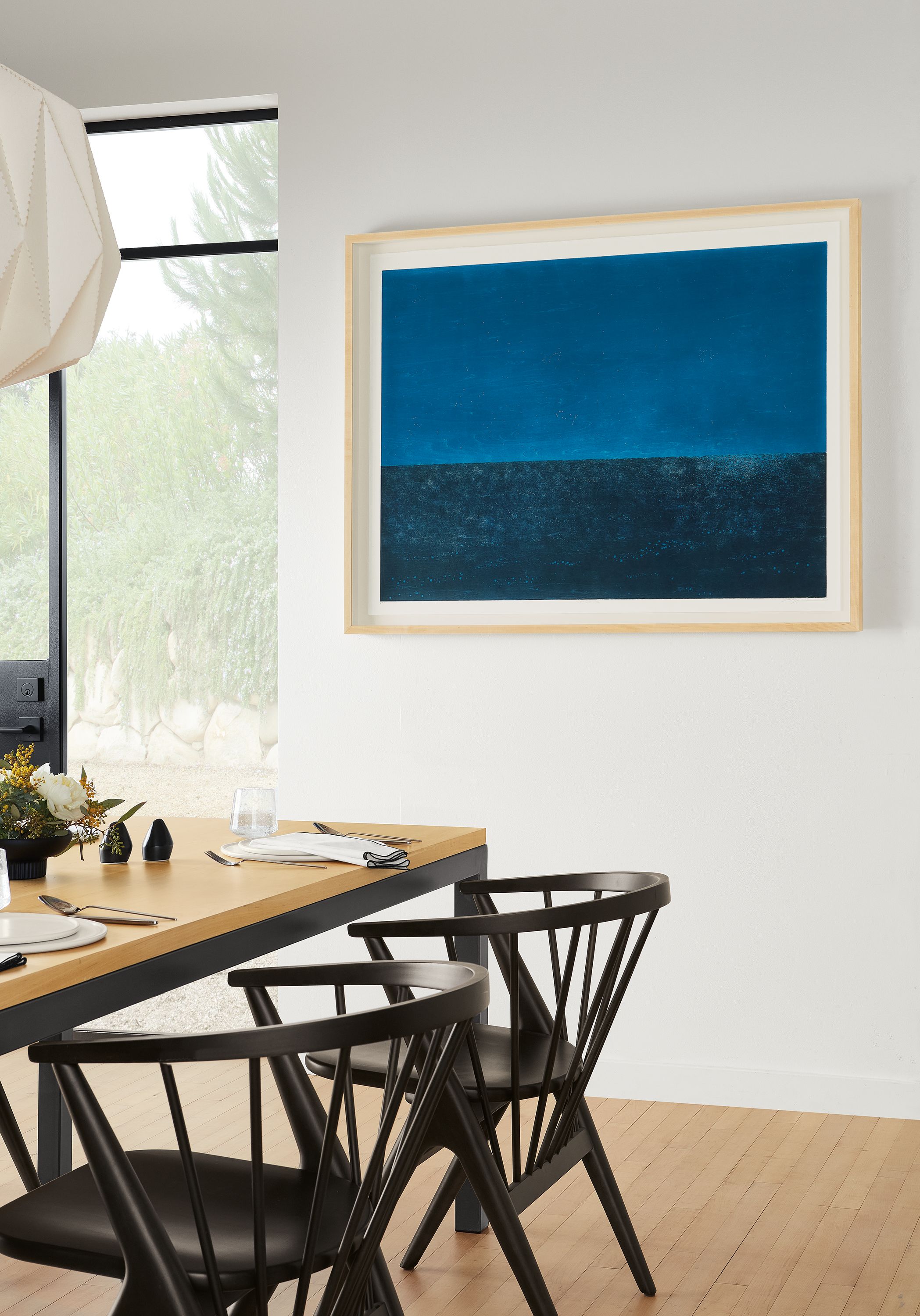 room setting including ayomi yoshida print and parsons table with soren arm chairs.