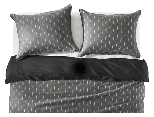 Front of zada duvet cover and shams in black on bed.